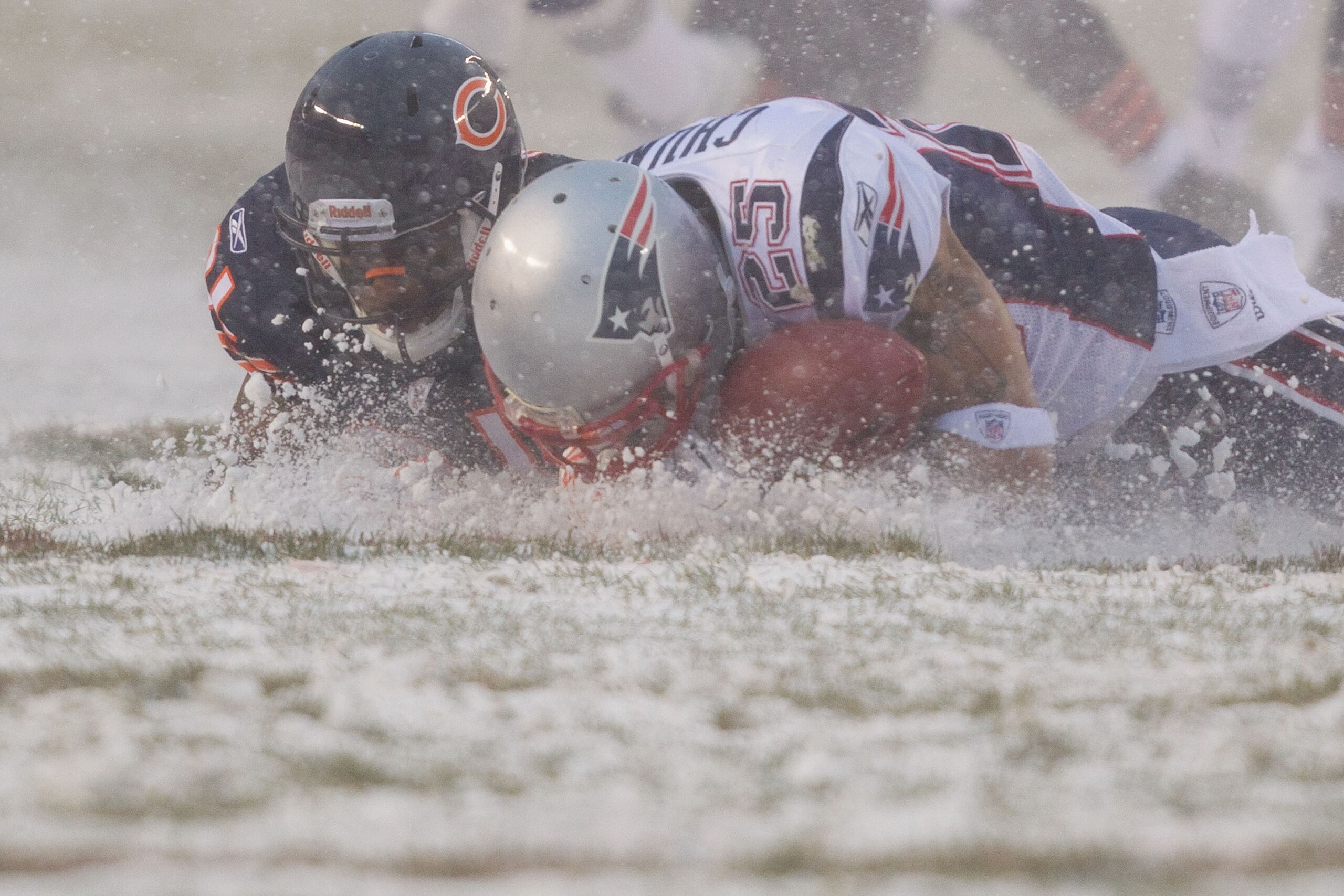 CHICAGO, IL - DECEMBER 12: Pat Chung #25 of the New England Patriots looks to recover a fumble Corey Graham #21 of the Chicago Bears at Soldier Field on December 12, 2010 in Chicago, Illinois.  The Patriots beat the Bears 36-7.  (Photo by Dilip Vishwanat/