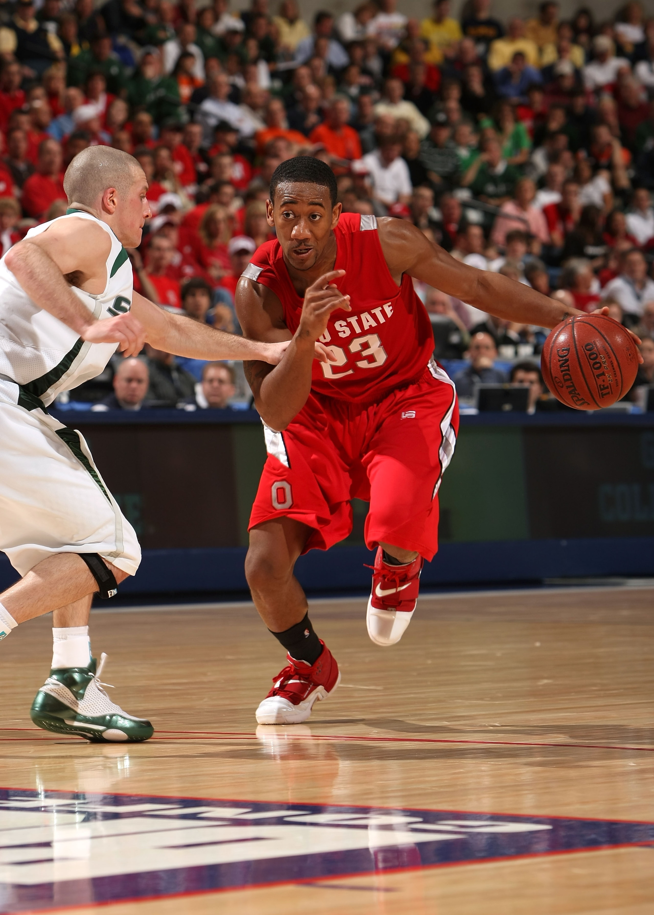 INDIANAPOLIS - MARCH 14:  David Lighty #23 of the Ohio State Buckeyes drives against Drew Neitzel #11 of the Michigan State Spartans during the Big Ten Men's Basketball Tournament at Conseco Fieldhouse on March 14, 2008 in Indianapolis, Indiana.  (Photo b
