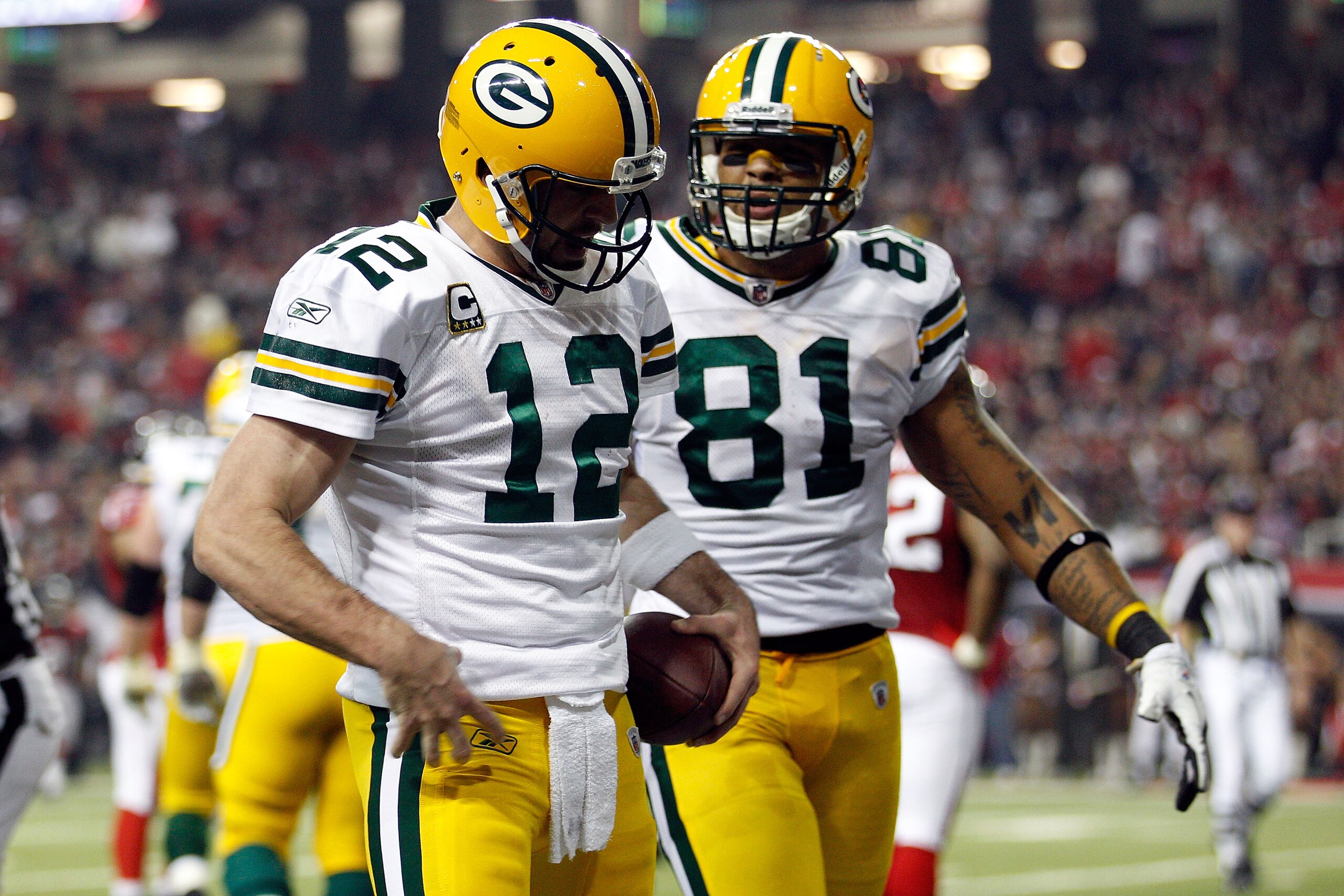 ATLANTA, GA - JANUARY 15:  Aaron Rodgers #12 and Andrew Quarless #81 of the Green Bay Packers celebrate after Rodgers scored a 7-yard rushing touchdown in the third quarter against the Atlanta Falcons during their 2011 NFC divisional playoff game at Georg