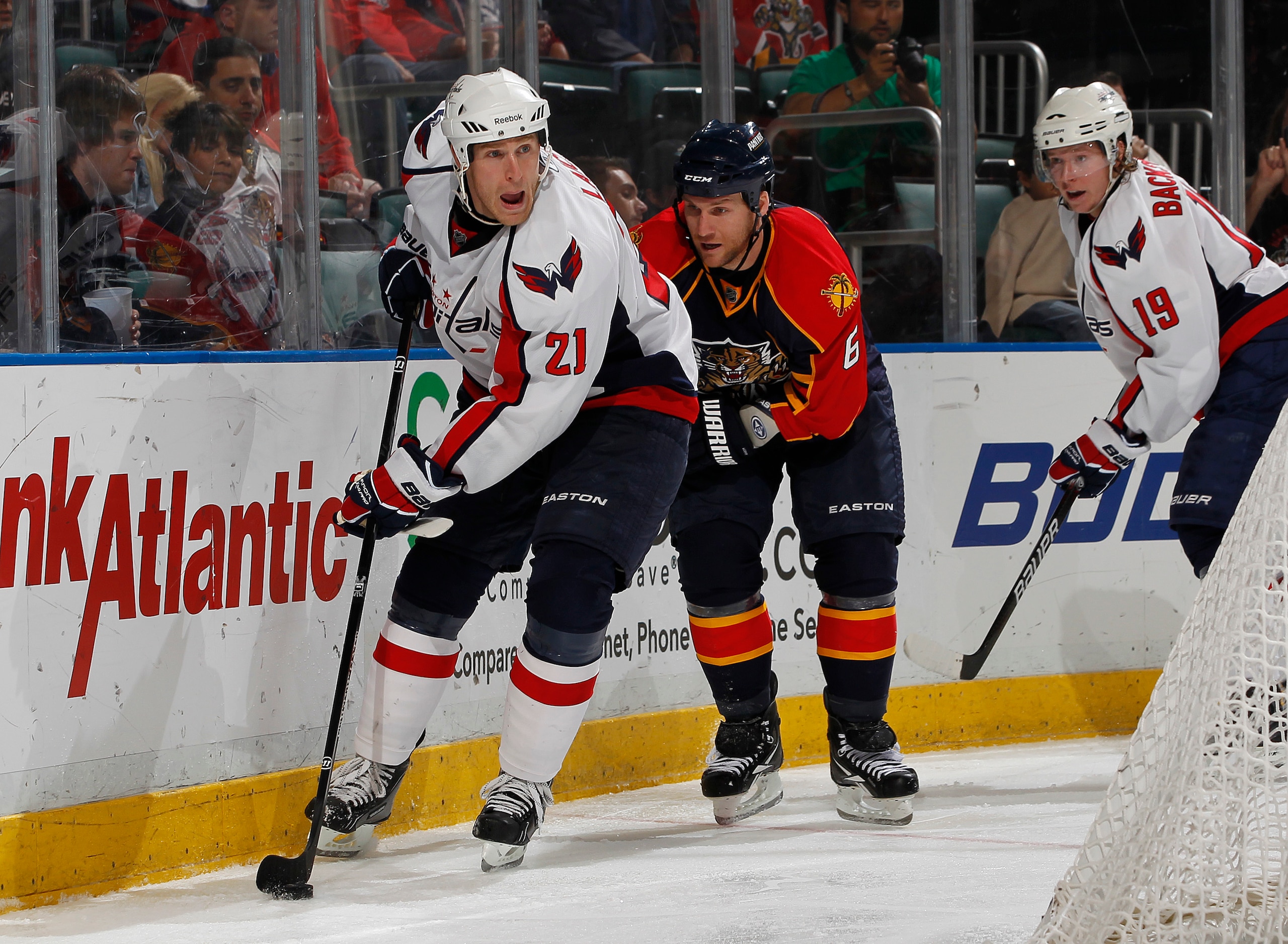 SUNRISE, FL - JANUARY 11: Brooks Laich #21 of the Washington Capitals attempts to pass the puck in front of the net while being defended by Dennis Wideman #6 of the Florida Panthers on January 11, 2011 at the BankAtlantic Center in Sunrise, Florida. (Phot