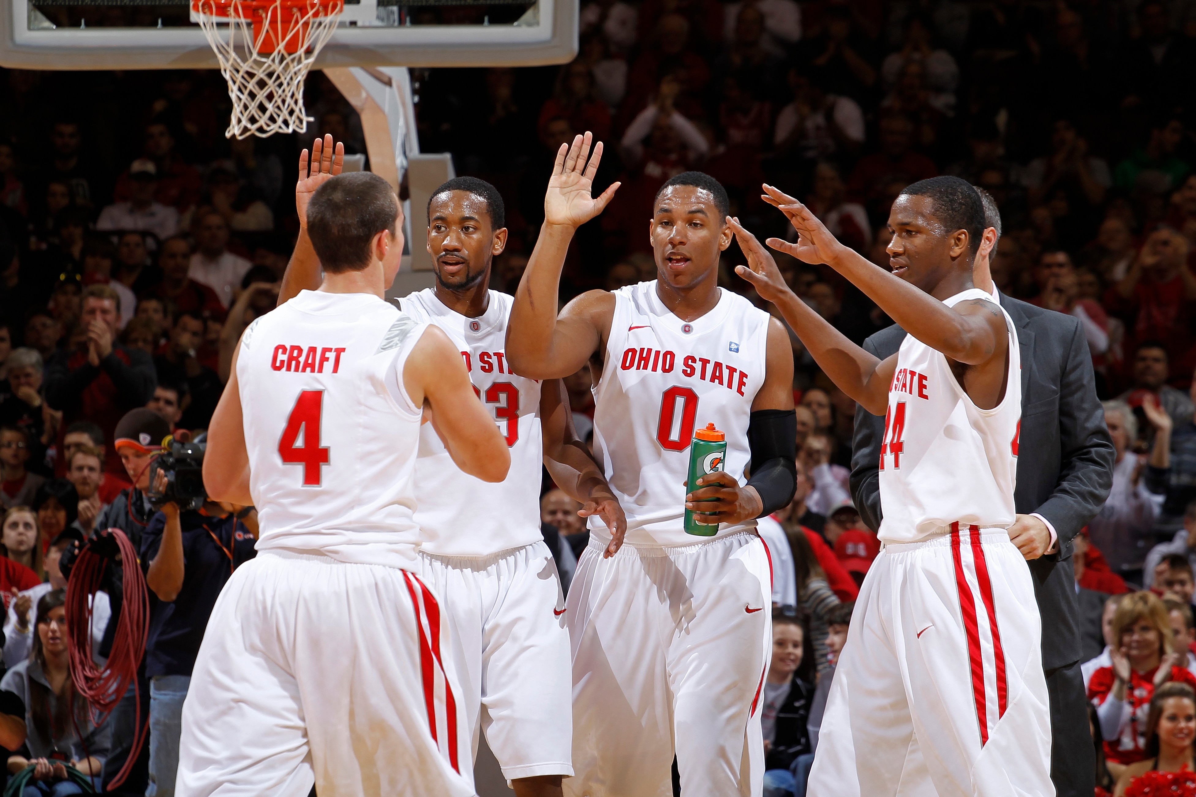COLUMBUS, OH - NOVEMBER 26: William Buford #44, Jared Sullinger #0, David Lighty #23 and Aaron Craft #4 of the Ohio State Buckeyes celebrate after a basket before a timeout in the game against the Miami RedHawks at Value City Arena on November 26, 2010 in