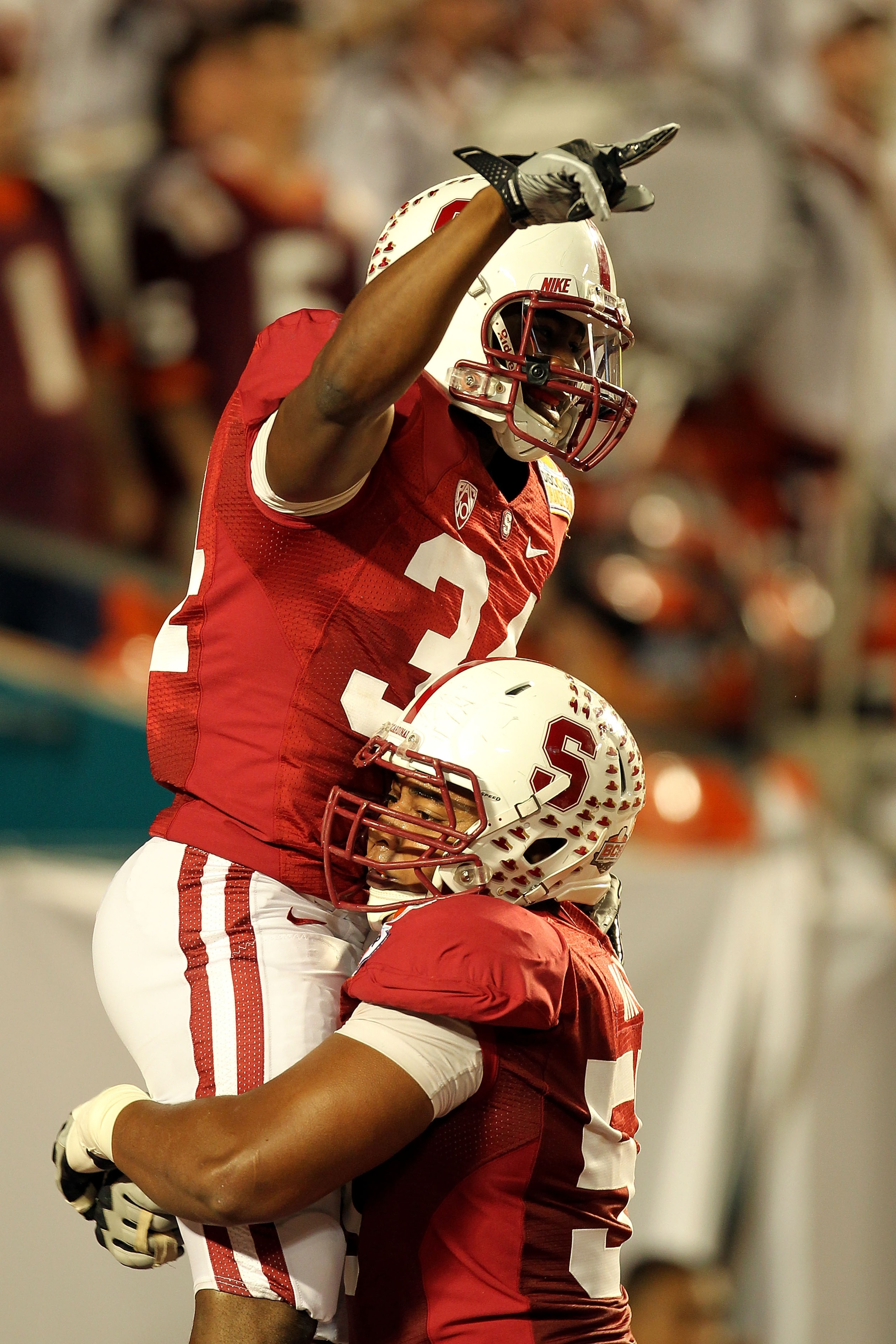 MIAMI, FL - JANUARY 03:  (L-R) Jeremy Stewart #34 and Jonathan Martin #55 of the Stanford Cardinal celebrate after Stewart scored a 60-yard rushing touchdown in the first quarter against the Virginai Tech Hokies during the 2011 Discover Orange Bowl at Sun