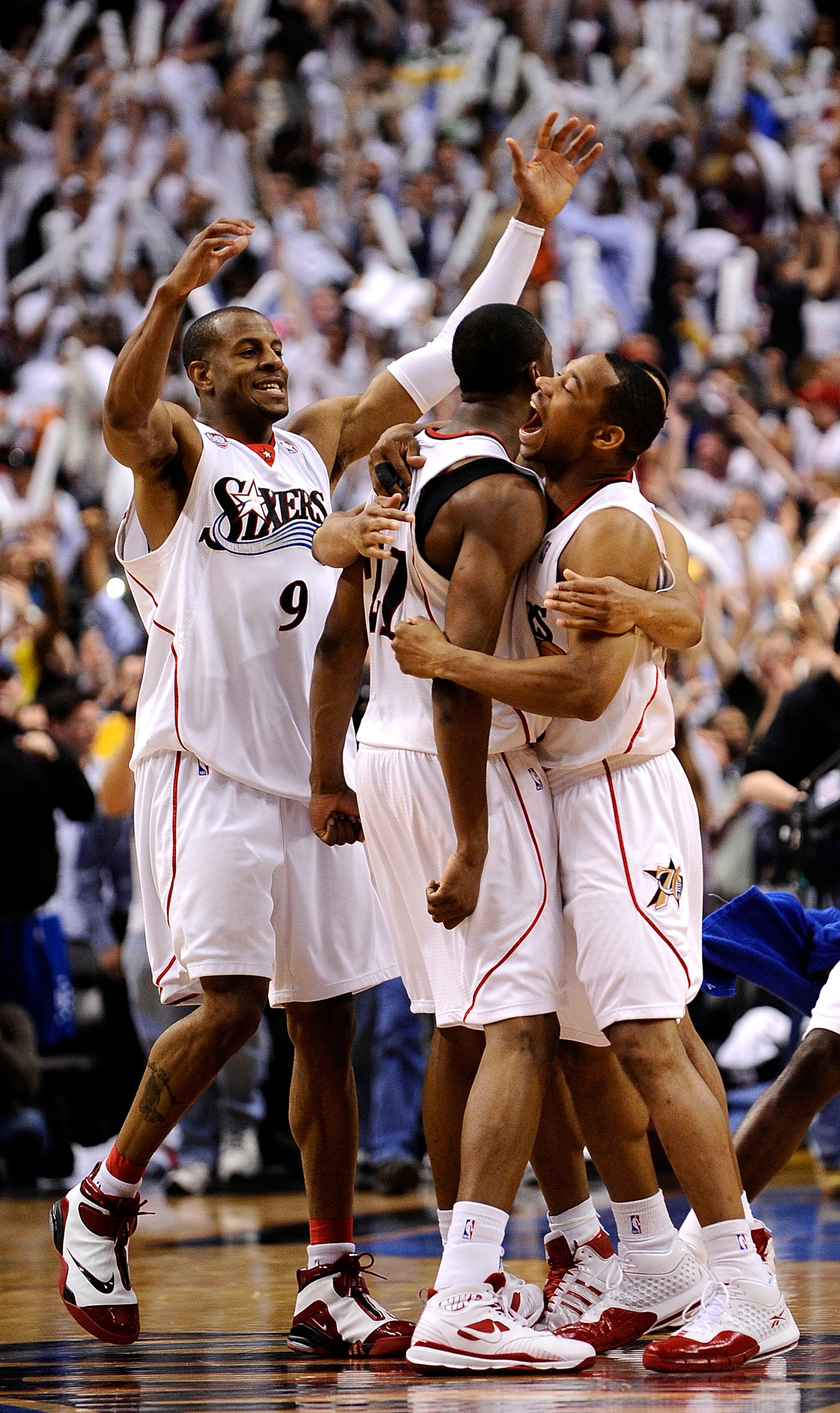 PHILADELPHIA - APRIL 24: Andre Iguodala #9 (L) and Lou WIlliams #23 (R) celebrate with Thaddeus Young #21 of the Philadelphia 76ers after Young's game-winning shot over the Orlando Magic during Game Three of the Eastern Conference Quarterfinals during the