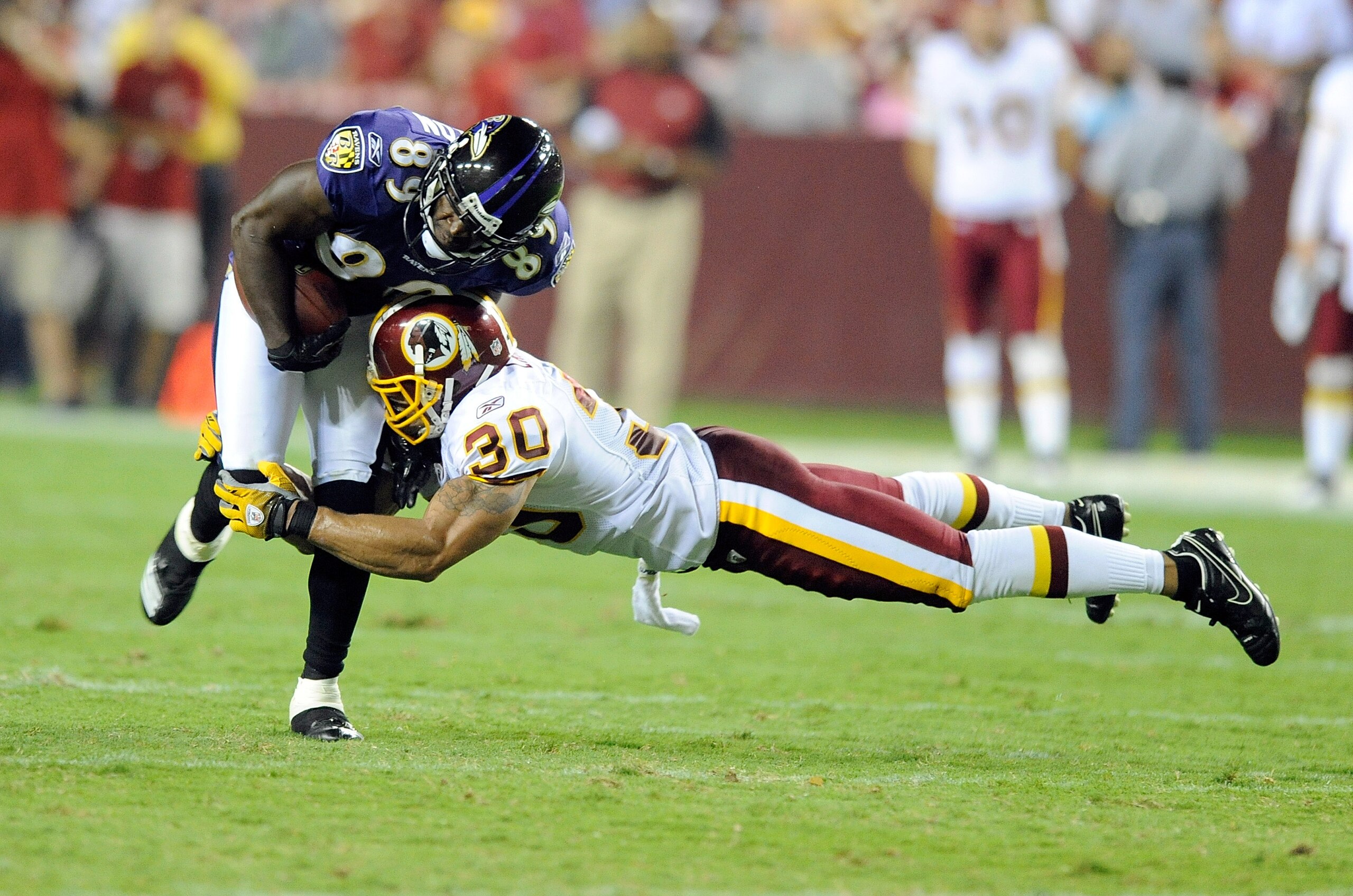 LANDOVER, MD - AUGUST 21:  Mark Clayton #89 of the Baltimore Ravens is tackled during the preseason game by LaRon Landry #30 of the Washington Redskins at FedExField on August 21, 2010 in Landover, Maryland.  (Photo by Greg Fiume/Getty Images)