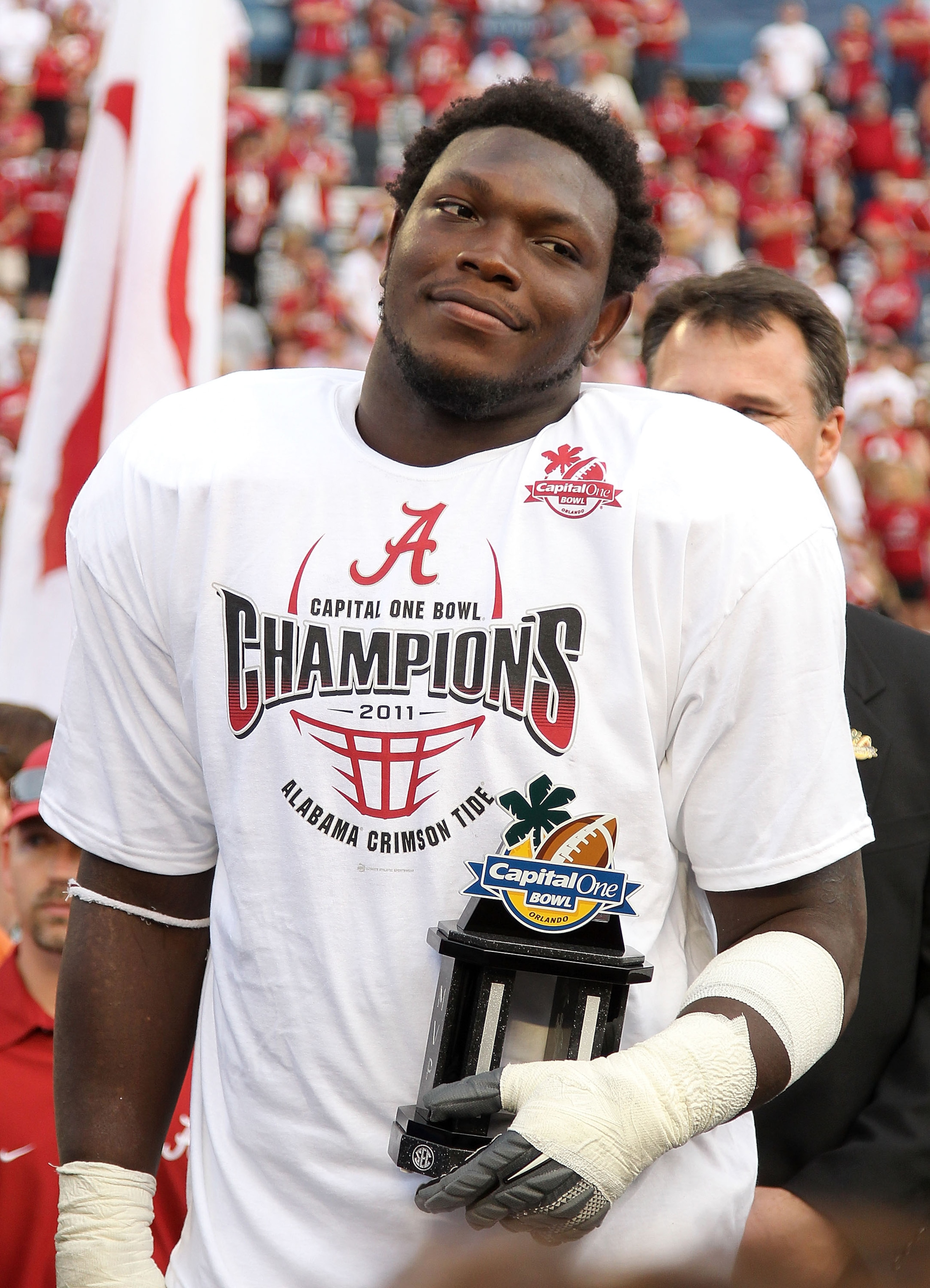 ORLANDO, FL - JANUARY 01:  Courtney Upshaw #41 of the Alabama Crimson Tide accepts the MVP award after winning the Capitol One Bowl against the Michigan State Spartans at the Florida Citrus Bowl on January 1, 2011 in Orlando, Florida.  (Photo by Mike Ehrm