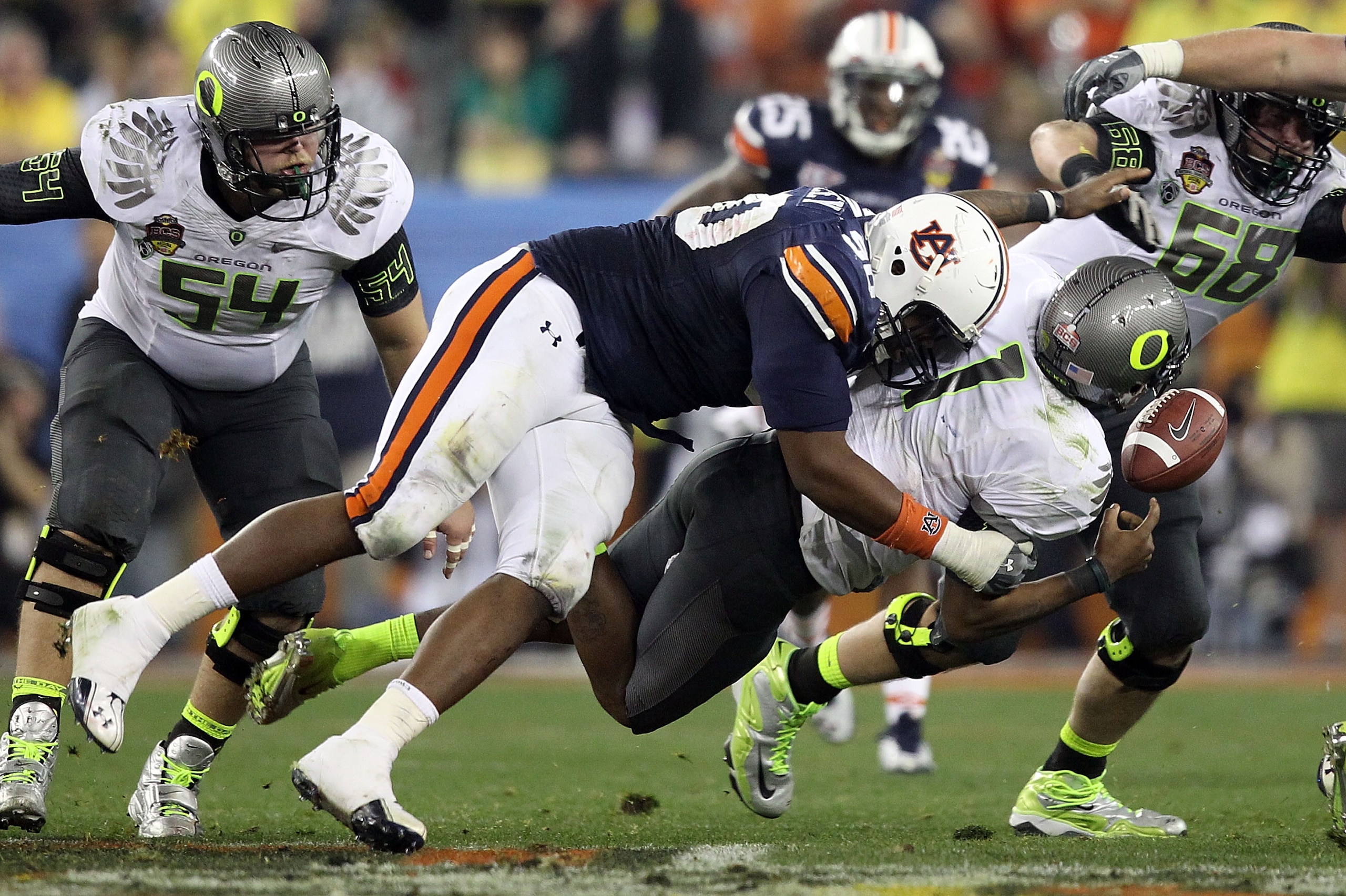 GLENDALE, AZ - JANUARY 10:  Nick Fairley #90 of the Auburn Tigers sacks Marvin Johnson #1 of the Oregon Ducks in the fourth quarter of the Tostitos BCS National Championship Game at University of Phoenix Stadium on January 10, 2011 in Glendale, Arizona.