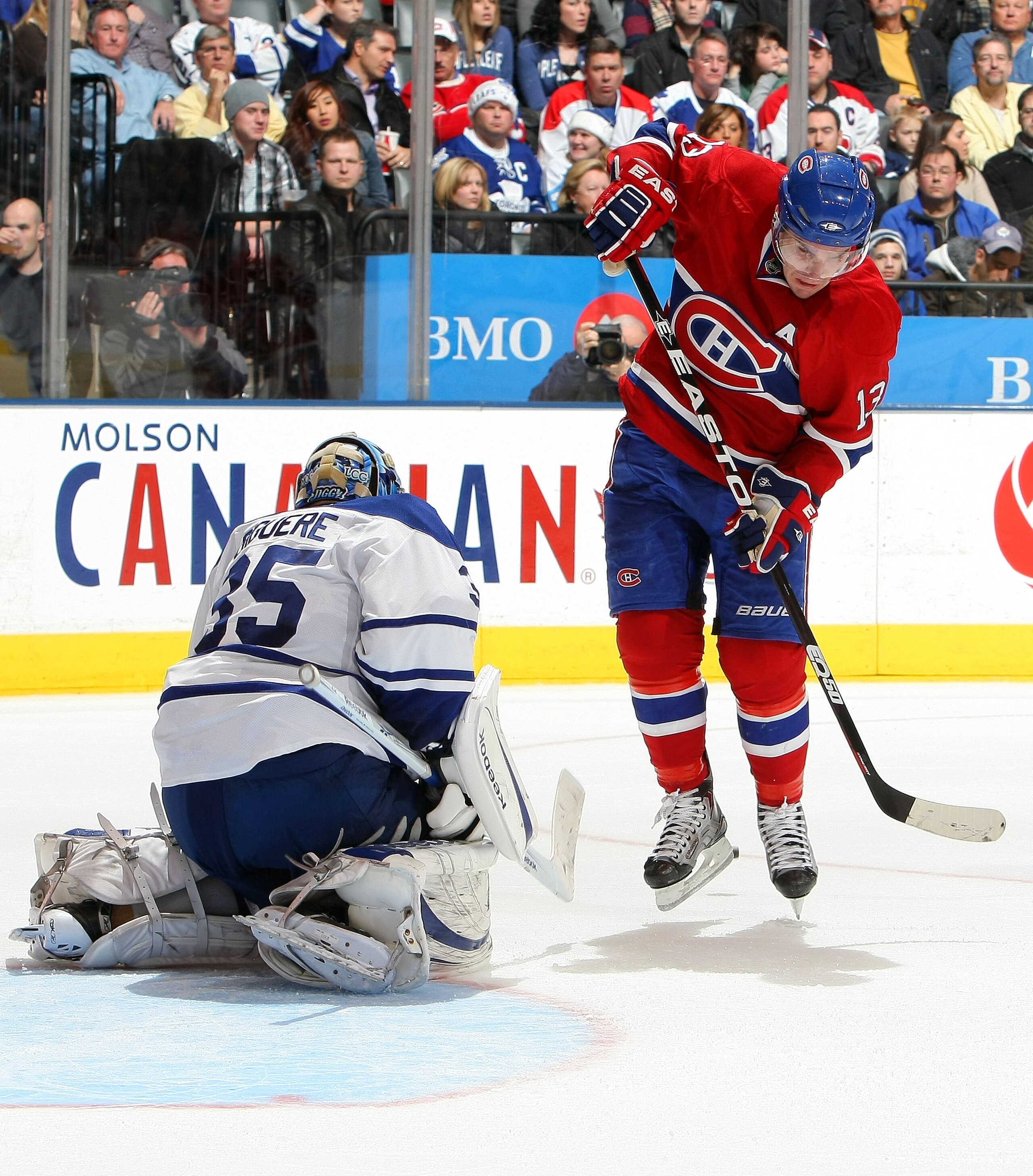 TORONTO - DECEMBER 11: Mike Cammalleri #13 of the Montreal Canadiens leaps to avoid a shot as Jean-Sebastien Giguere #35 of the Toronto Maple Leafs makes a save during their NHL game at Air Canada Centre on December 11, 2010 in Toronto, Ontario, Canada.( TORONTO - DECEMBER 11: Mike Cammalleri #13 of the Montreal Canadiens leaps to avoid a shot as Jean-Sebastien Giguere #35 of the Toronto Maple Leafs makes a save during their NHL game at Air Canada Centre on December 11, 2010 in Toronto, Ontario, Canada.(