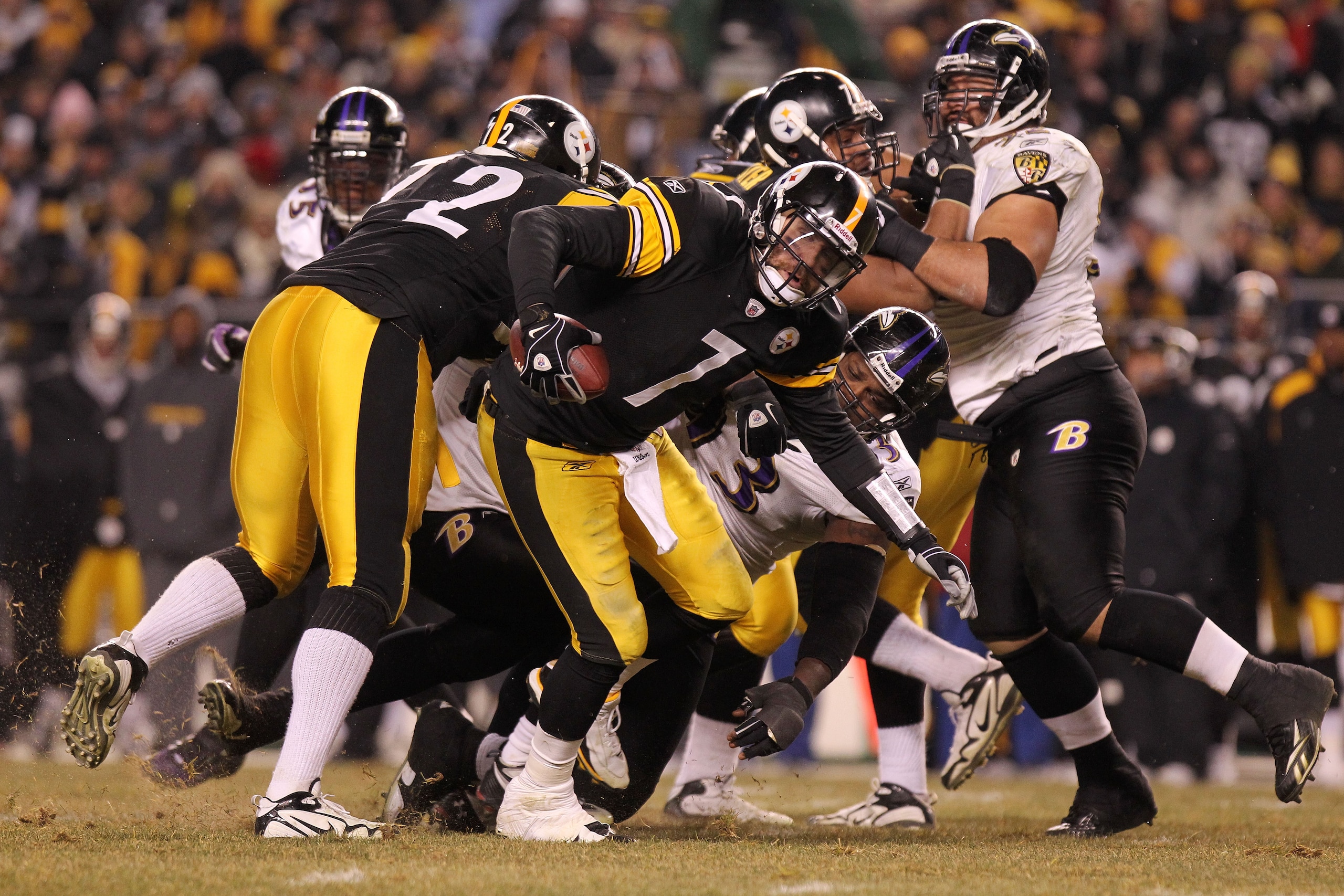 PITTSBURGH, PA - JANUARY 15:  Quarterback Ben Roethlisberger #7 of the Pittsburgh Steelers breaks a tackle by defensive end Cory Redding #93 of the Baltimore Ravens in the AFC Divisional Playoff Game at Heinz Field on January 15, 2011 in Pittsburgh, Penns