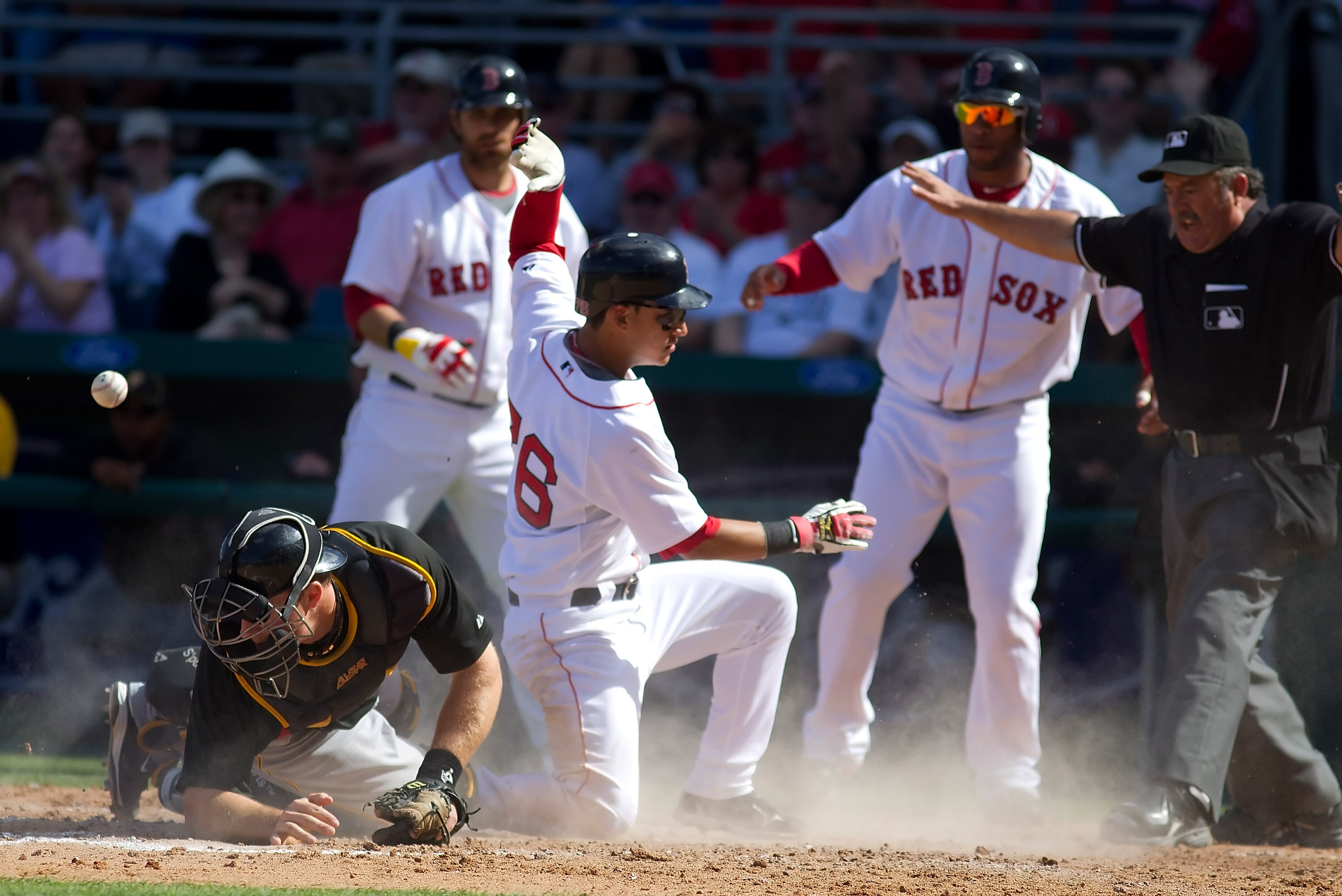 FORT MYERS, FL - MARCH 13:  Catcher Erik Kratz #67 of the Pittsburgh Pirates  cannot handle the throw as infielder Jose Iglesias #76 of the Boston Red Sox scores during a Grapefruit League Spring Training Game at City of Palms Park on March 13, 2010 in Fo