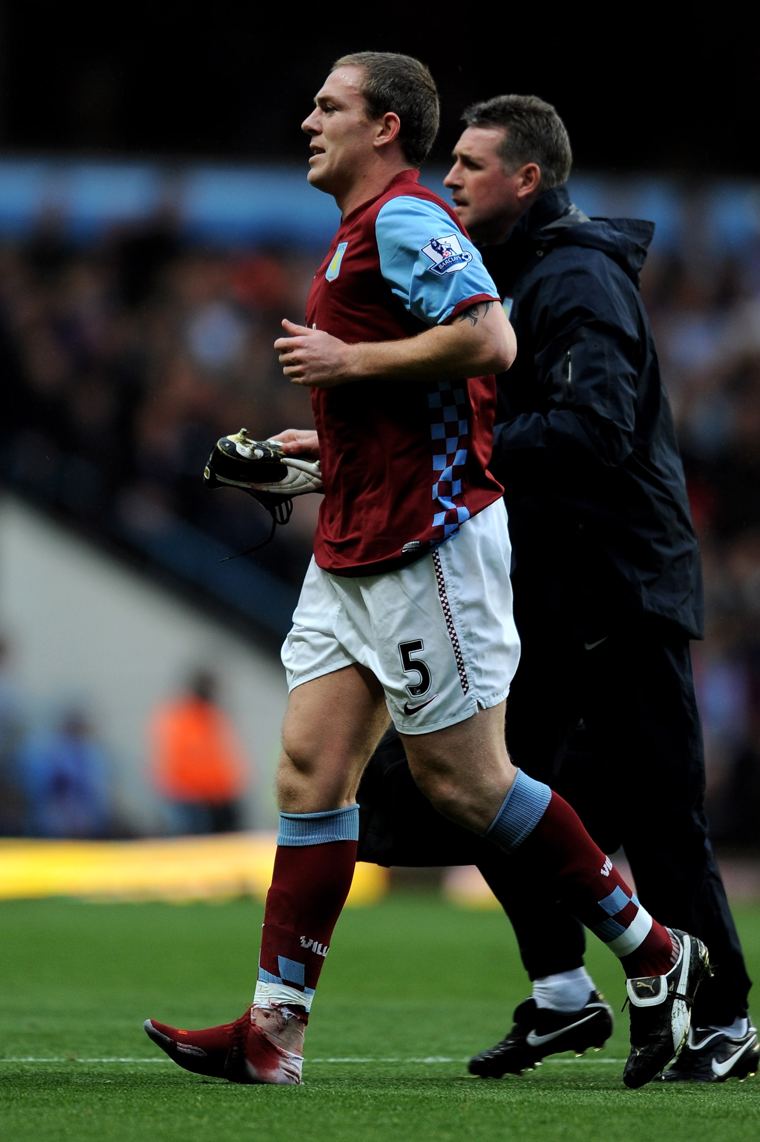 BIRMINGHAM, ENGLAND - OCTOBER 16:  Richard Dunne of Aston Villa leaves the field after sustaining an injury during the Barclays Premier League match between Aston Villa and Chelsea at Villa Park on October 16, 2010 in Birmingham, England.  (Photo by Micha