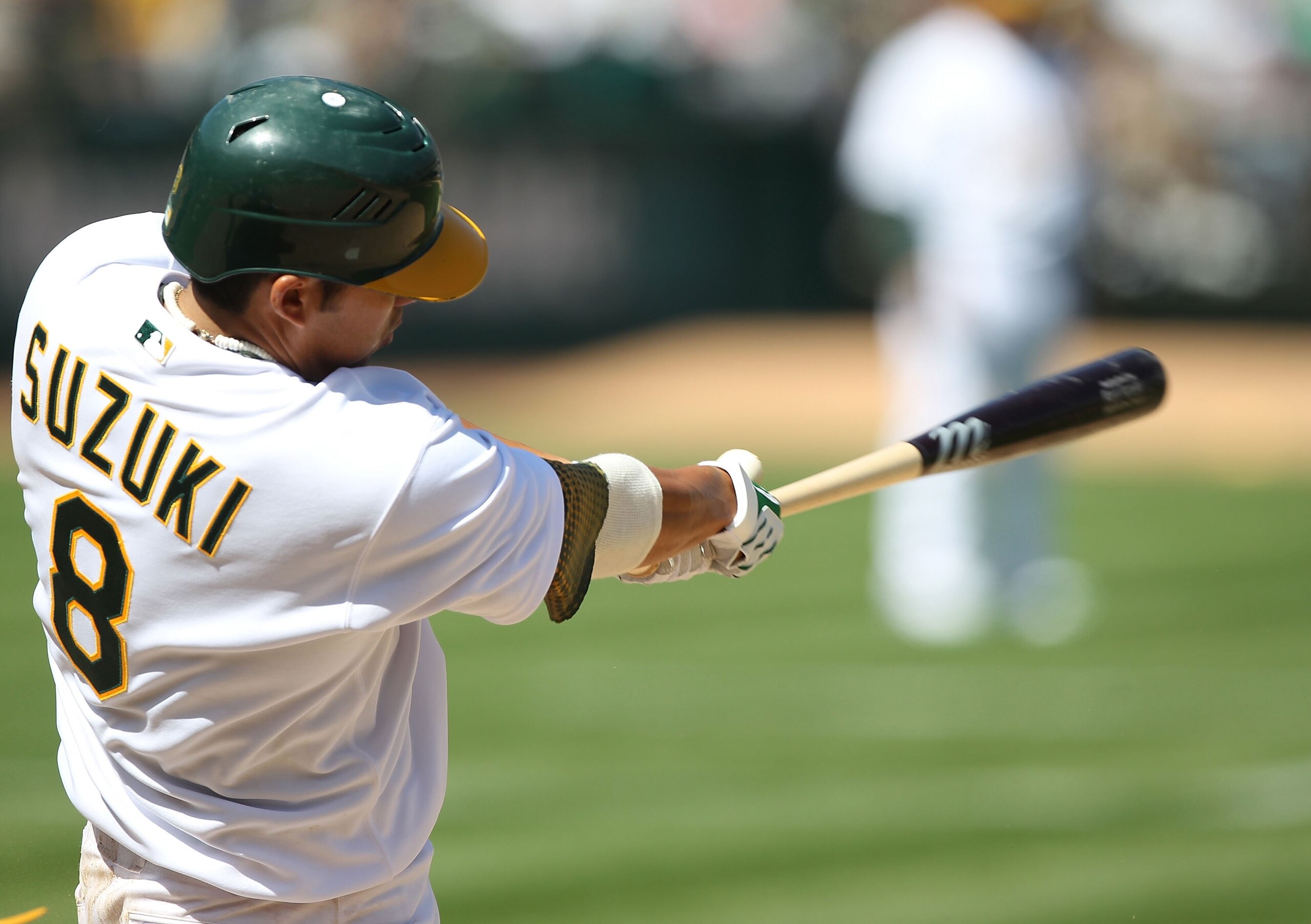 OAKLAND, CA - APRIL 08:  Kurt Suzuki #8 of the Oakland Athletics bats against the Seattle Mariners during an MLB game at the Oakland-Alameda County Coliseum on April 8, 2010 in Oakland, California.  (Photo by Jed Jacobsohn/Getty Images)