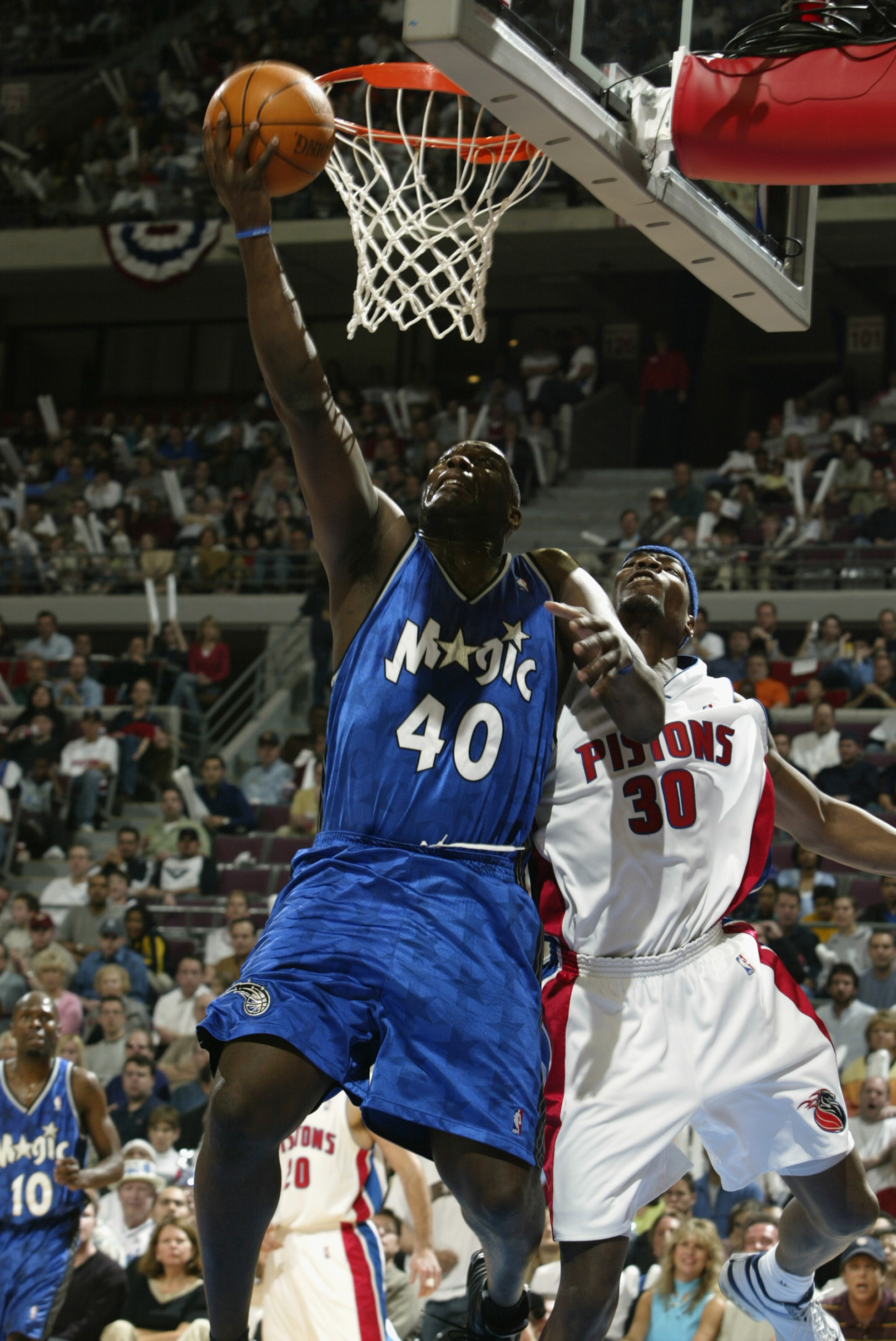 AUBURN HILLS, MI - APRIL 20: Shawn Kemp #40 of the Orlando Magic shoots past Clifford Robinson #30 of the Detroit Pistons in Game one of the Eastern Conference Quarterfinals during the 2003 NBA Playoffs at The Palace of Auburn Hills on April 20, 2003 in AUBURN HILLS, MI - APRIL 20: Shawn Kemp #40 of the Orlando Magic shoots past Clifford Robinson #30 of the Detroit Pistons in Game one of the Eastern Conference Quarterfinals during the 2003 NBA Playoffs at The Palace of Auburn Hills on April 20, 2003 in
