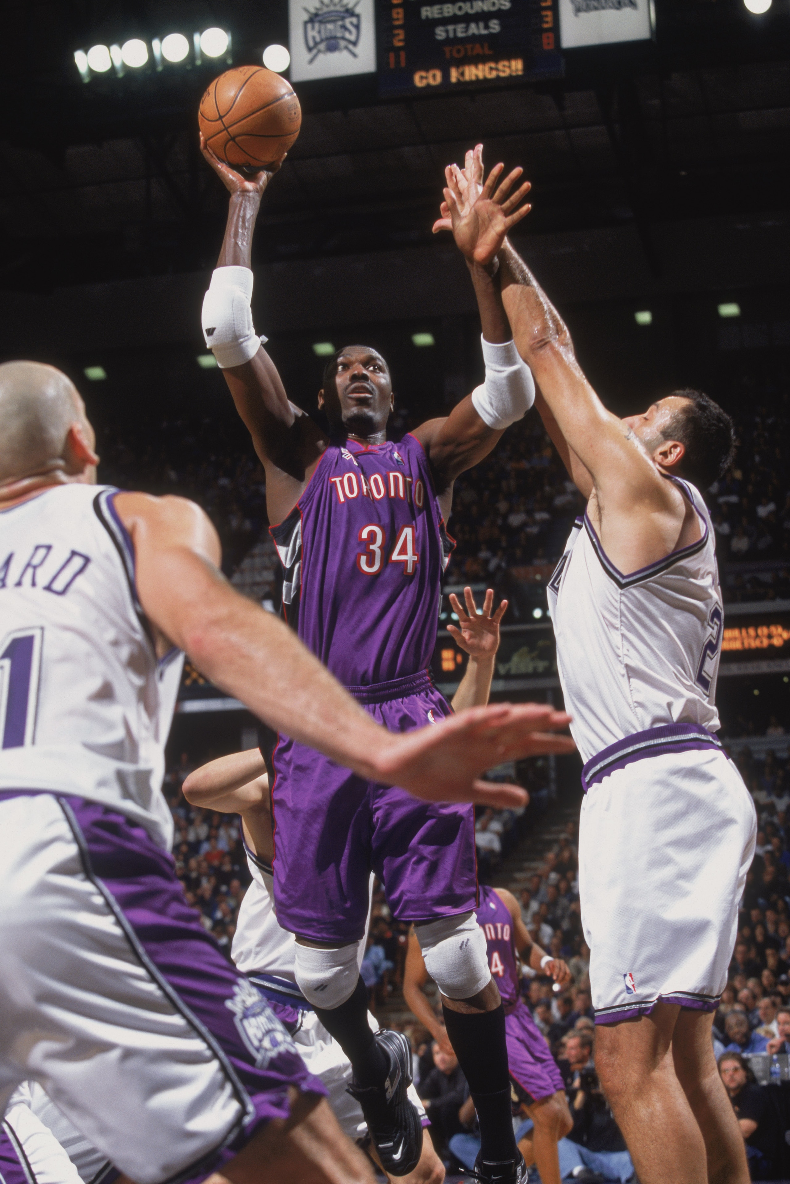 14 Nov 2001: Center Hakeem Olajuwon #34 of the Toronto Raptors shoots the ball past center Vlade Divac #21 of the Sacramento Kings during the NBA game at Arco Arena in Sacramento, California. The Kings defeated the Raptors 95-86. NOTE TO USER: User expr 14 Nov 2001: Center Hakeem Olajuwon #34 of the Toronto Raptors shoots the ball past center Vlade Divac #21 of the Sacramento Kings during the NBA game at Arco Arena in Sacramento, California. The Kings defeated the Raptors 95-86. NOTE TO USER: User expr