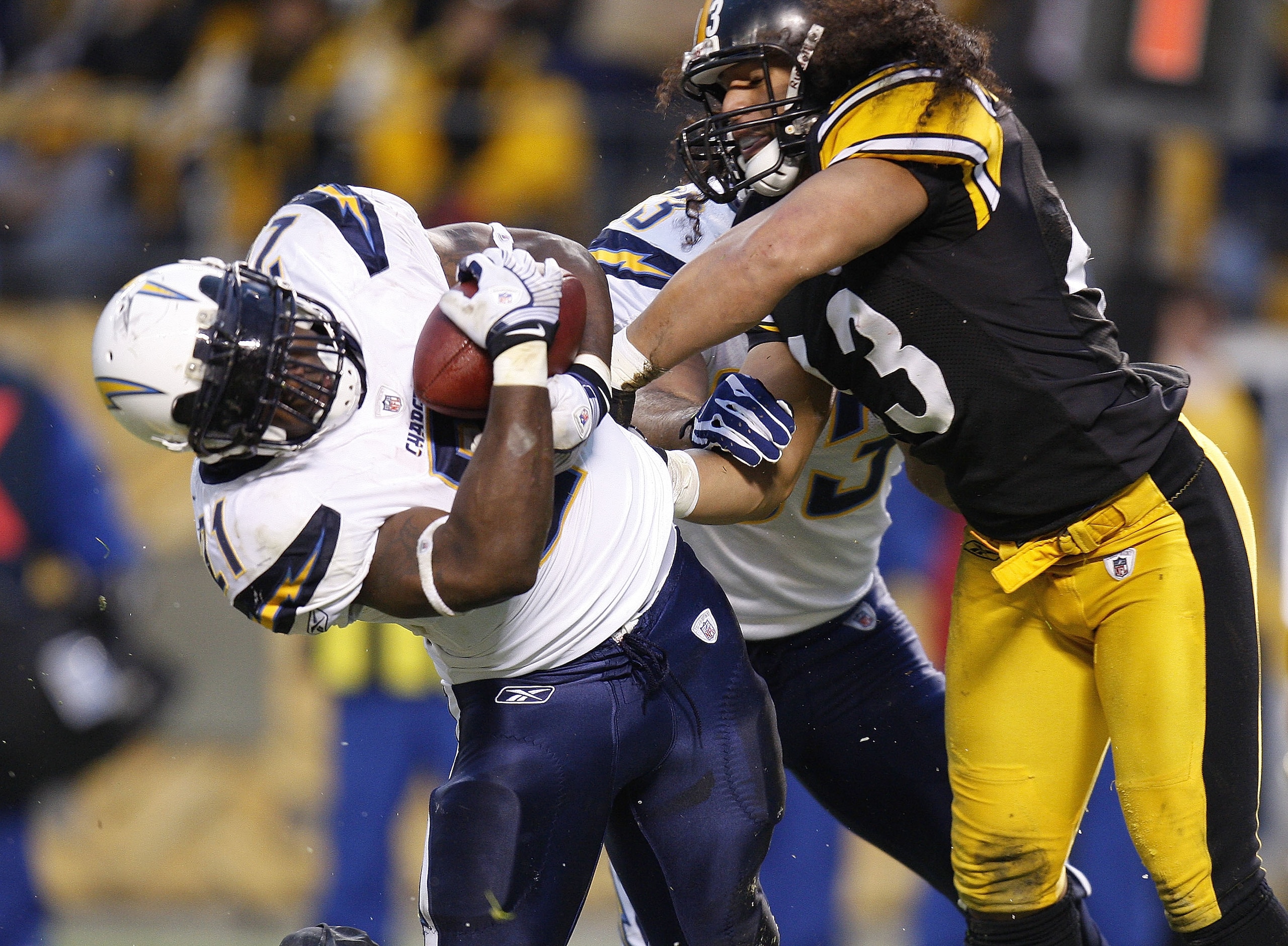 PITTSBURGH - NOVEMBER 16:  LaDanian Tomlinson #21 of the San Diego Chargers scores a first quarter touchdown while taking a hit from Troy Polamalu #43 of the Pittsburgh Steelers during the second quarter on November 16, 2008 at Heinz Field in Pittsburgh, 