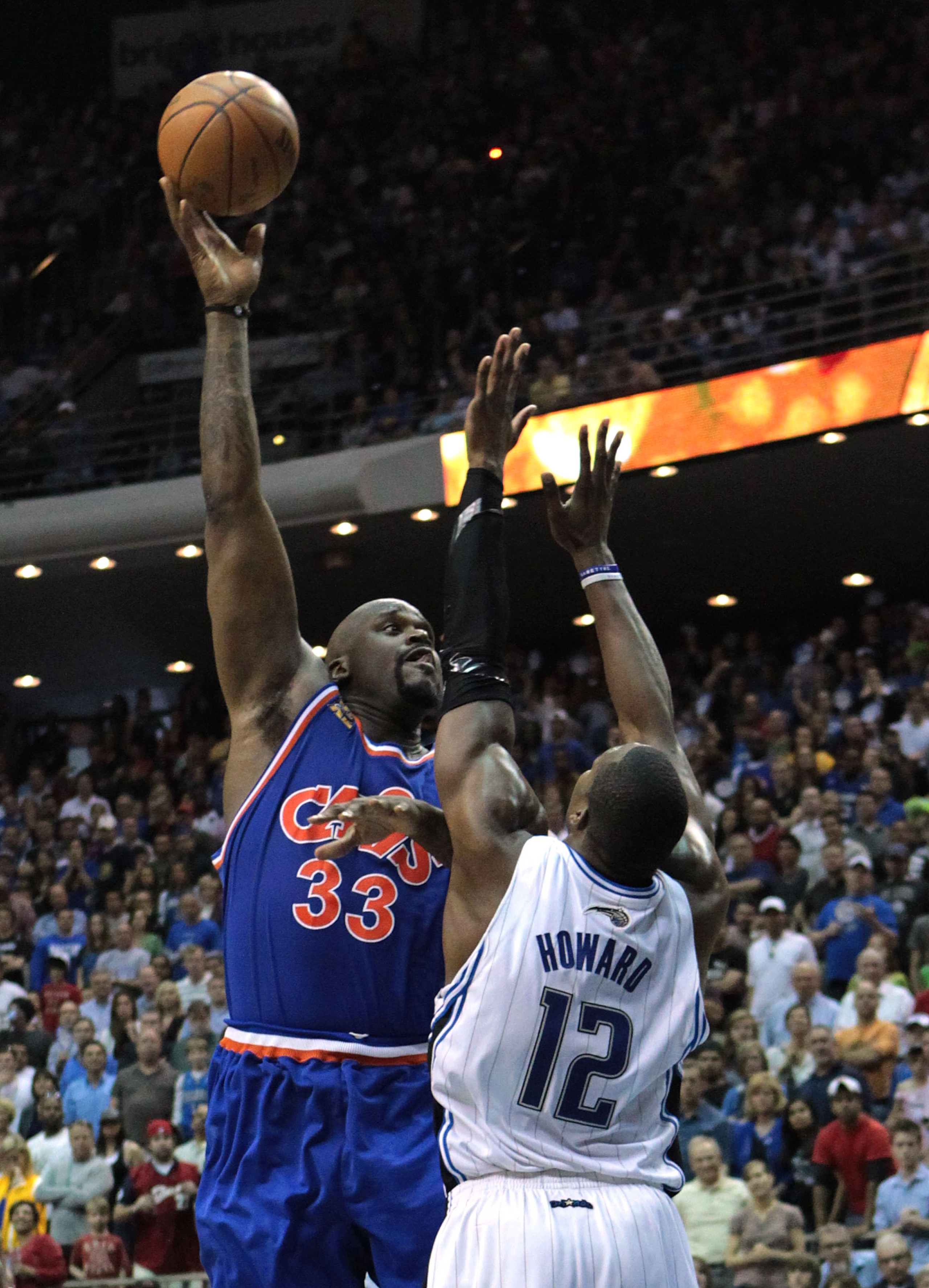 ORLANDO, FL - FEBRUARY 21: Shaquille O'Neal #33 of the Cleveland Cavaliers attempts a shot over Dwight Howard #12 of the Orlando Magic at Amway Arena on February 21, 2010 in Orlando, Florida. NOTE TO USER: User expressly acknowledges and agrees that, by ORLANDO, FL - FEBRUARY 21: Shaquille O'Neal #33 of the Cleveland Cavaliers attempts a shot over Dwight Howard #12 of the Orlando Magic at Amway Arena on February 21, 2010 in Orlando, Florida. NOTE TO USER: User expressly acknowledges and agrees that, by