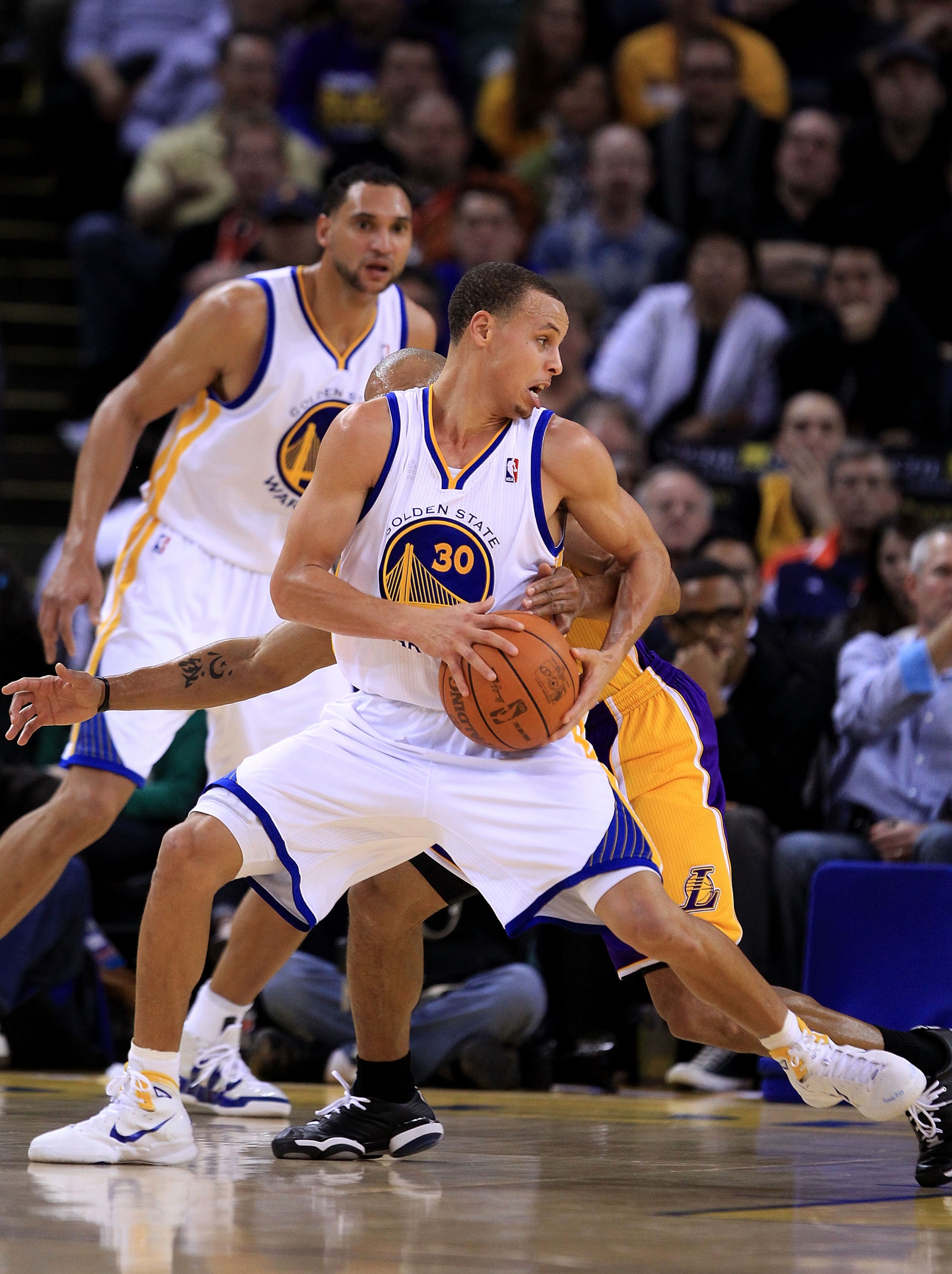 OAKLAND, CA - JANUARY 12:  Stephen Curry #30 of the Golden State Warriors in action against the Los Angeles Lakers at Oracle Arena on January 12, 2011 in Oakland, California. NOTE TO USER: User expressly acknowledges and agrees that, by downloading and or