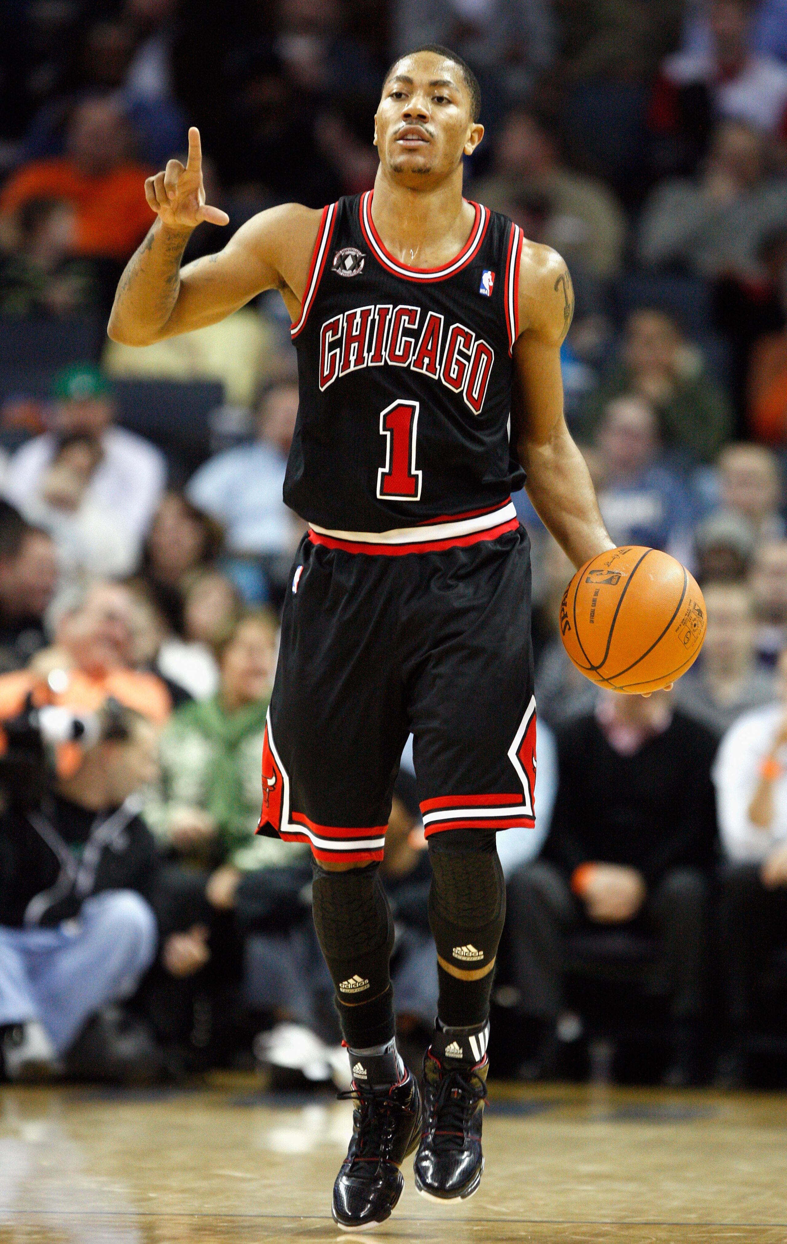 CHARLOTTE, NC - JANUARY 12:  Derrick Rose #1 of the Chicago Bulls calls a play against the Charlotte Bobcats during their game at Time Warner Cable Arena on January 12, 2011 in Charlotte, North Carolina. NOTE TO USER: User expressly acknowledges and agree