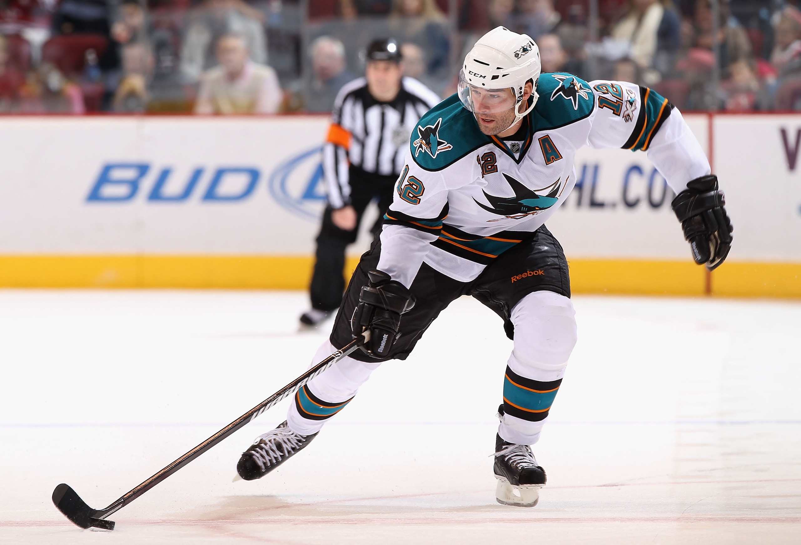 GLENDALE, AZ - JANUARY 17:  Patrick Marleau #12 of the San Jose Sharks skates up ice with the puck during the NHL game against the Phoenix Coyotes at Jobing.com Arena on January 17, 2011 in Glendale, Arizona.   Patrick Marleau played his 1,000th career ga