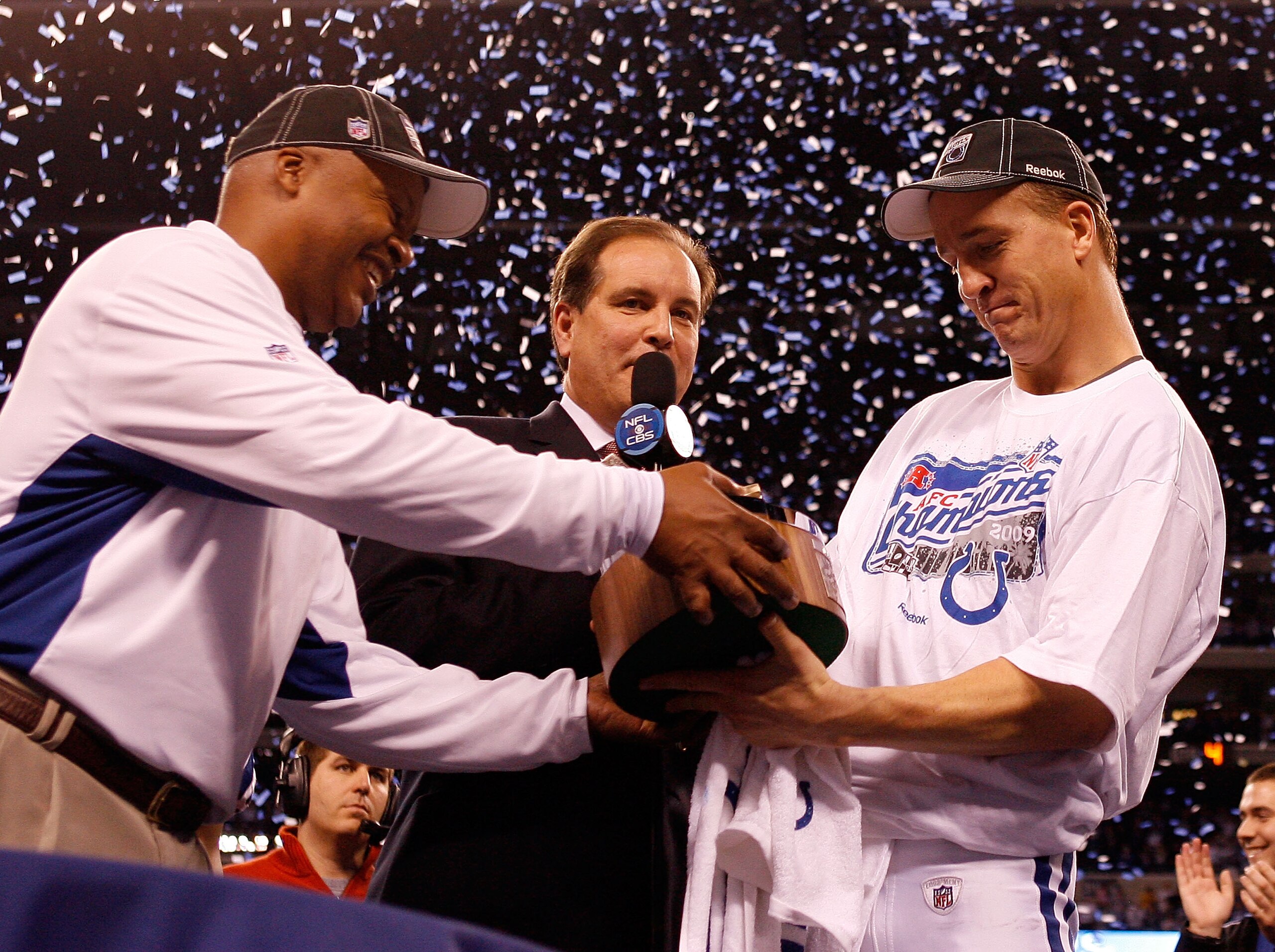INDIANAPOLIS - JANUARY 24:  Head coach Jim Caldwell hands quarterback Peyton Manning #18 of the Indianapolis Colts the Lamar Hunt trophy after the Colts defeated the New York Jets 30-17 to win the AFC Championship Game at Lucas Oil Stadium on January 24,