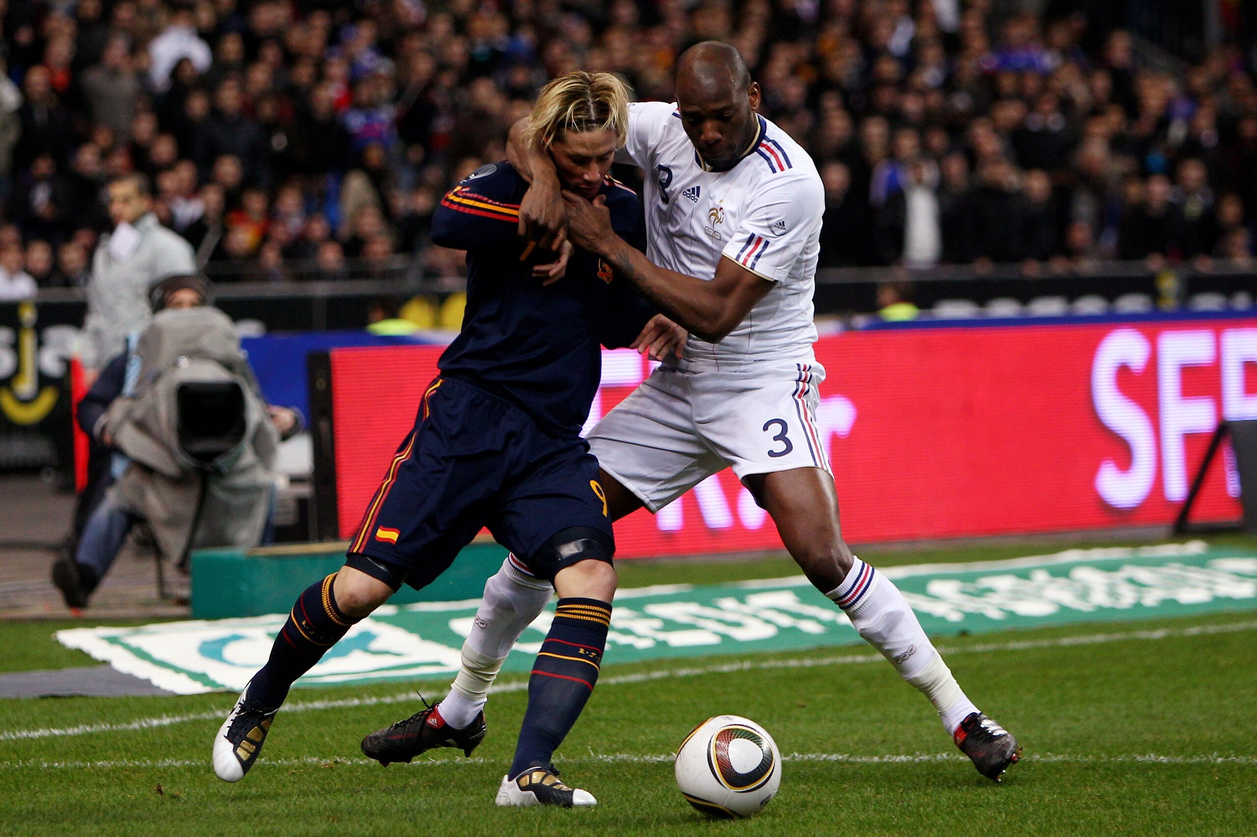 PARIS - MARCH 03:  Fernando Torres (l) of Spain challenged by Michael Ciani (r) during the during the International friendly match betweem France and Spain at the Stade de France on March 3, 2010 in Paris, France.  (Photo by Michael Steele/Getty Images)