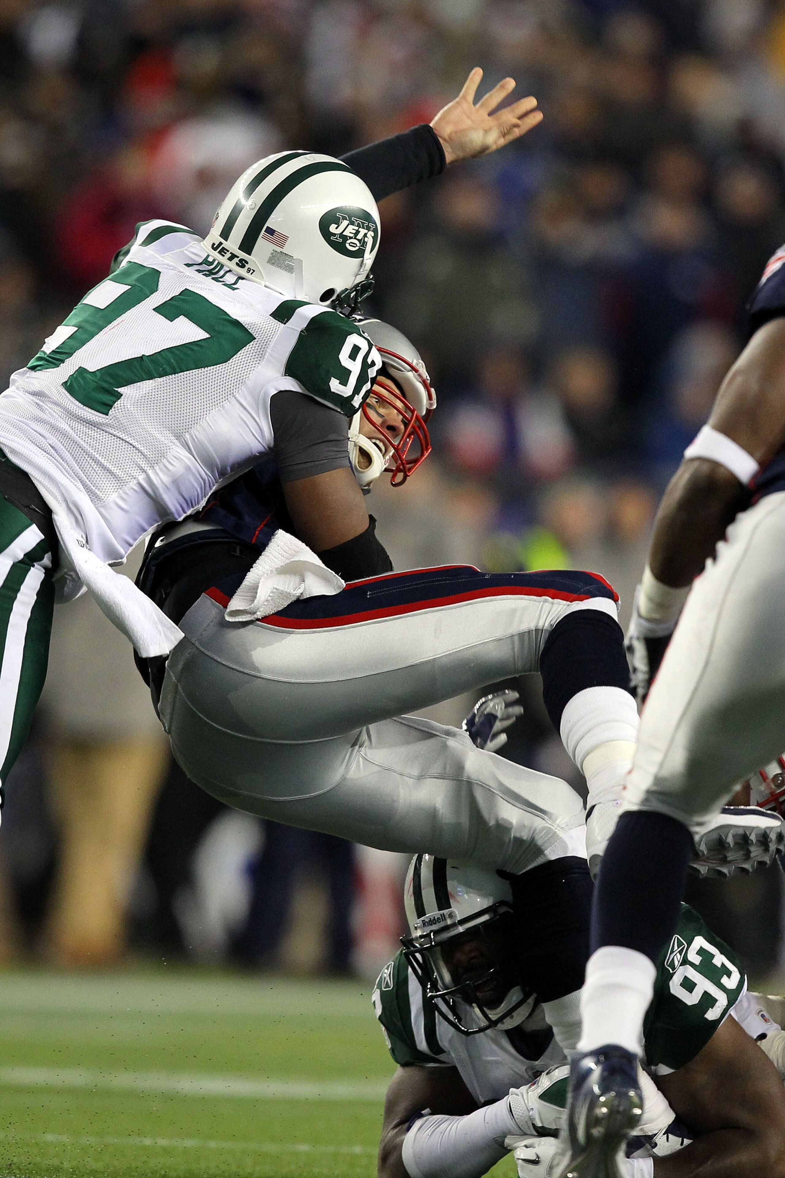 FOXBORO, MA - JANUARY 16:  Tom Brady #12 of the New England Patriots looses the ball as he is sacked by Calvin Pace #97 of the New York Jets in the third quarter of their 2011 AFC divisional playoff game at Gillette Stadium on January 16, 2011 in Foxboro,