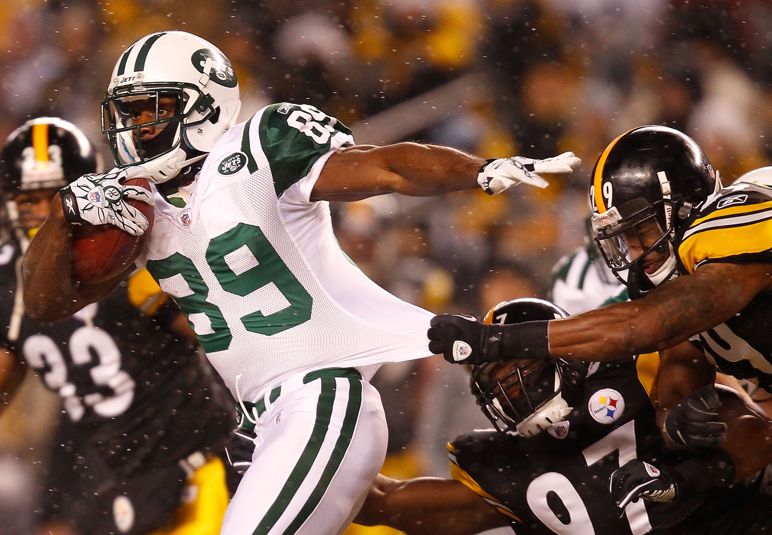 PITTSBURGH - DECEMBER 19: Jerricho Cotchery #89 of the New York Jets runs through a tackle by Ryan Mundy #29 of the Pittsburgh Steelers during the game on December 19, 2010 at Heinz Field in Pittsburgh, Pennsylvania. (Photo by Jared Wickerham/Getty Imag PITTSBURGH - DECEMBER 19: Jerricho Cotchery #89 of the New York Jets runs through a tackle by Ryan Mundy #29 of the Pittsburgh Steelers during the game on December 19, 2010 at Heinz Field in Pittsburgh, Pennsylvania. (Photo by Jared Wickerham/Getty Imag