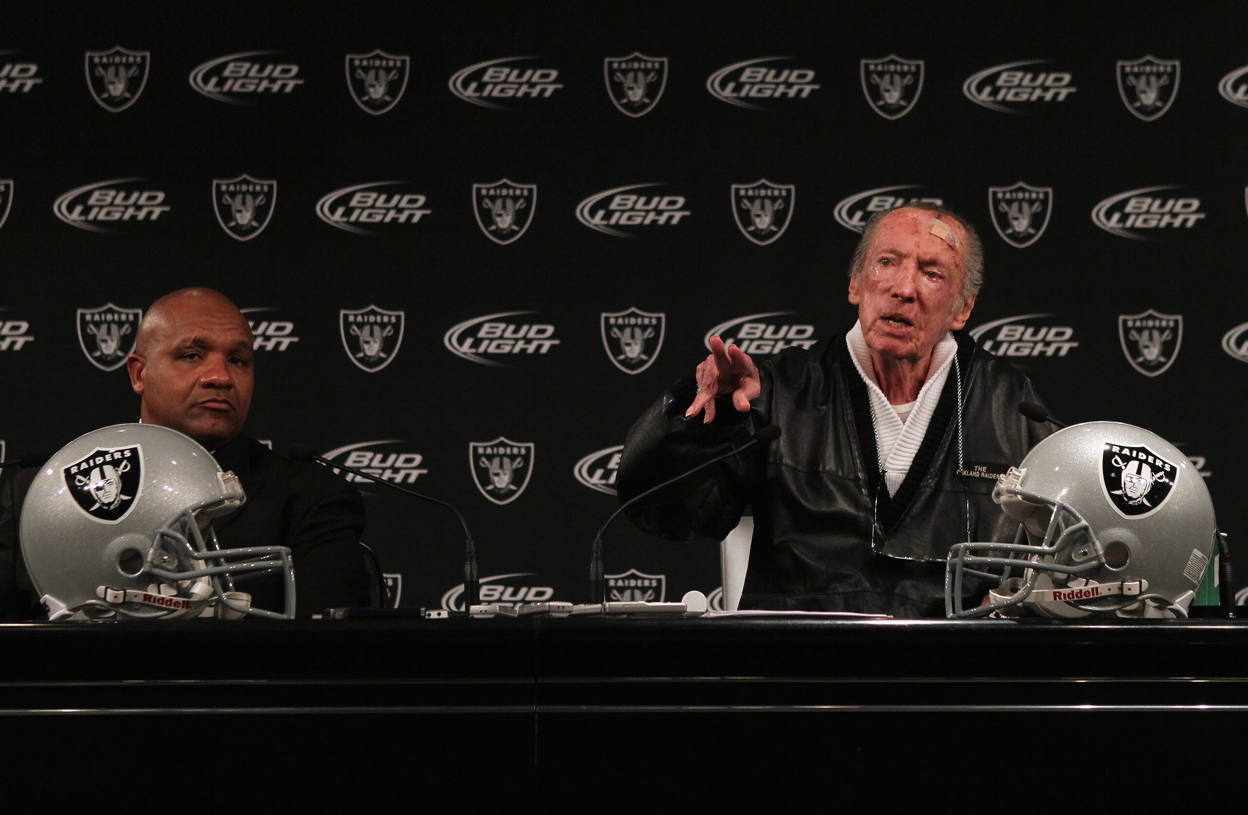 ALAMEDA, CA - JANUARY 18:  New Oakland Raiders coach Hue Jackson (L) looks on as Raiders owner Al Davis speaks during a press conference on January 18, 2011 in Alameda, California. Hue Jackson was introduced as the new coach of the Oakland Raiders, replac
