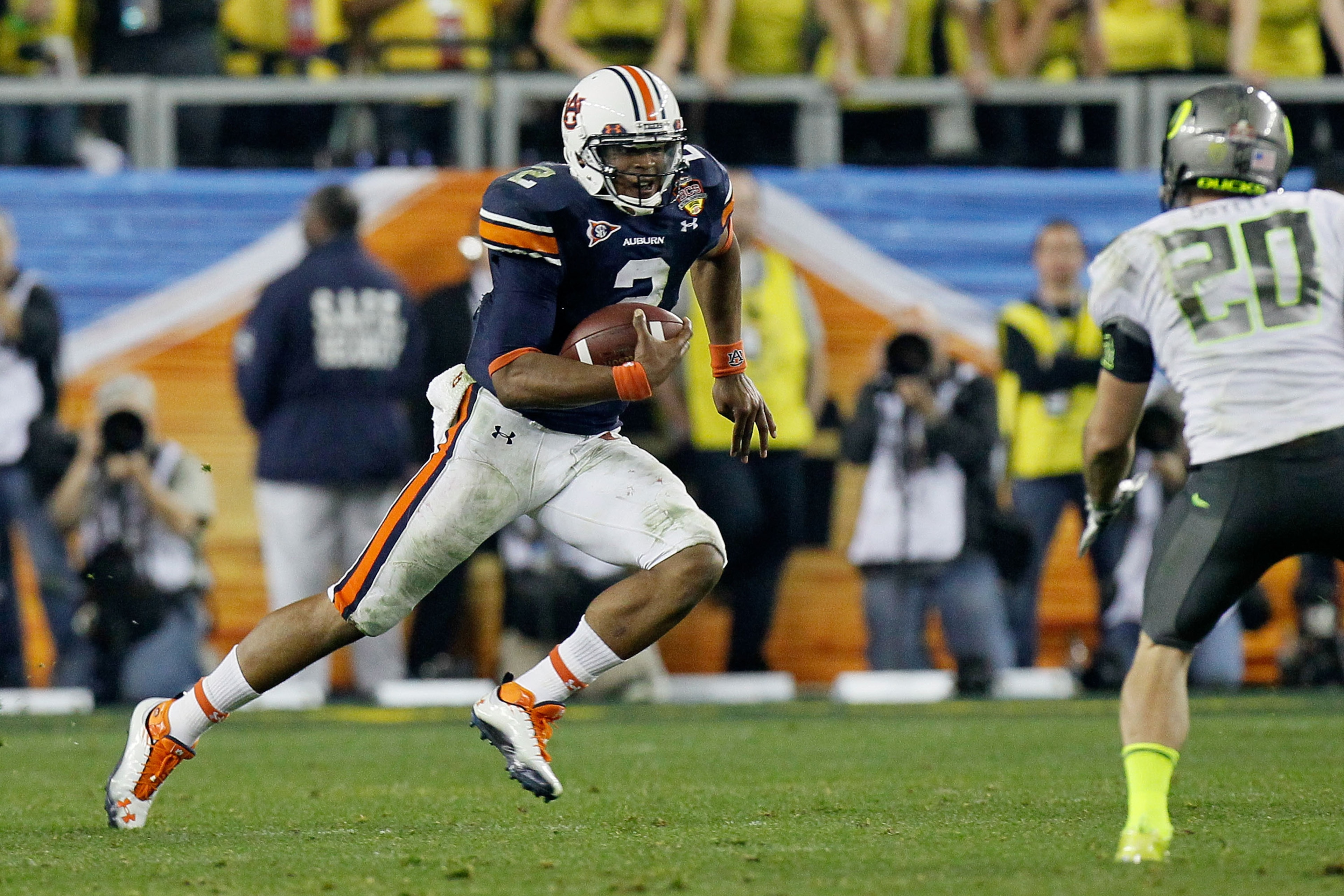 GLENDALE, AZ - JANUARY 10: Cameron Newton #2 of the Auburn Tigers runs down field against John Boyett #20 of the Oregon Ducks during the Tostitos BCS National Championship Game at University of Phoenix Stadium on January 10, 2011 in Glendale, Arizona. ( GLENDALE, AZ - JANUARY 10: Cameron Newton #2 of the Auburn Tigers runs down field against John Boyett #20 of the Oregon Ducks during the Tostitos BCS National Championship Game at University of Phoenix Stadium on January 10, 2011 in Glendale, Arizona. (