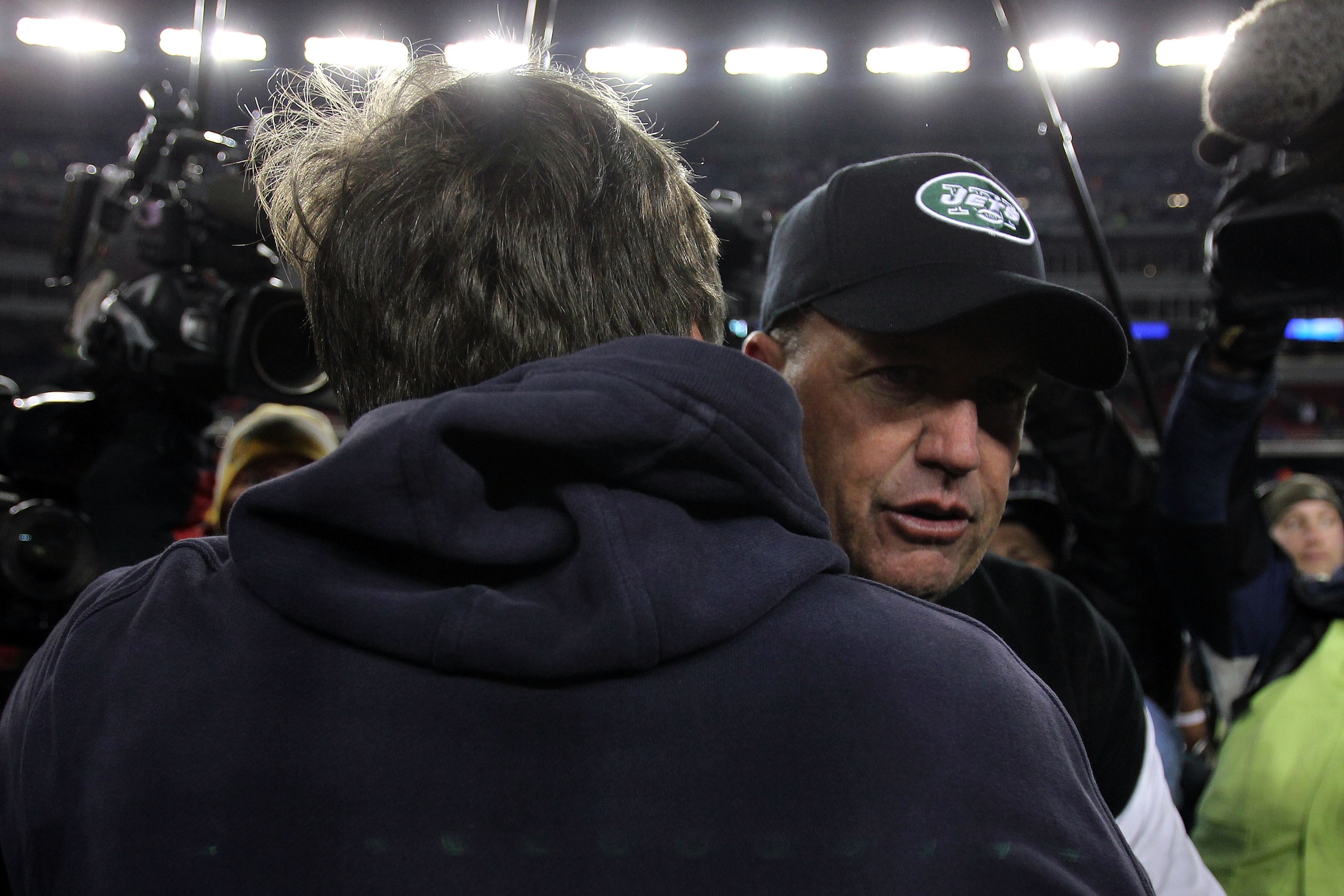 FOXBORO, MA - JANUARY 16:  Head coach Rex Ryan of the New York Jets hugs head coach Bill Belichick of the New England Patriots after the Jets defeated the Patriots 28 to 21 during their 2011 AFC divisional playoff game at Gillette Stadium on January 16, 2