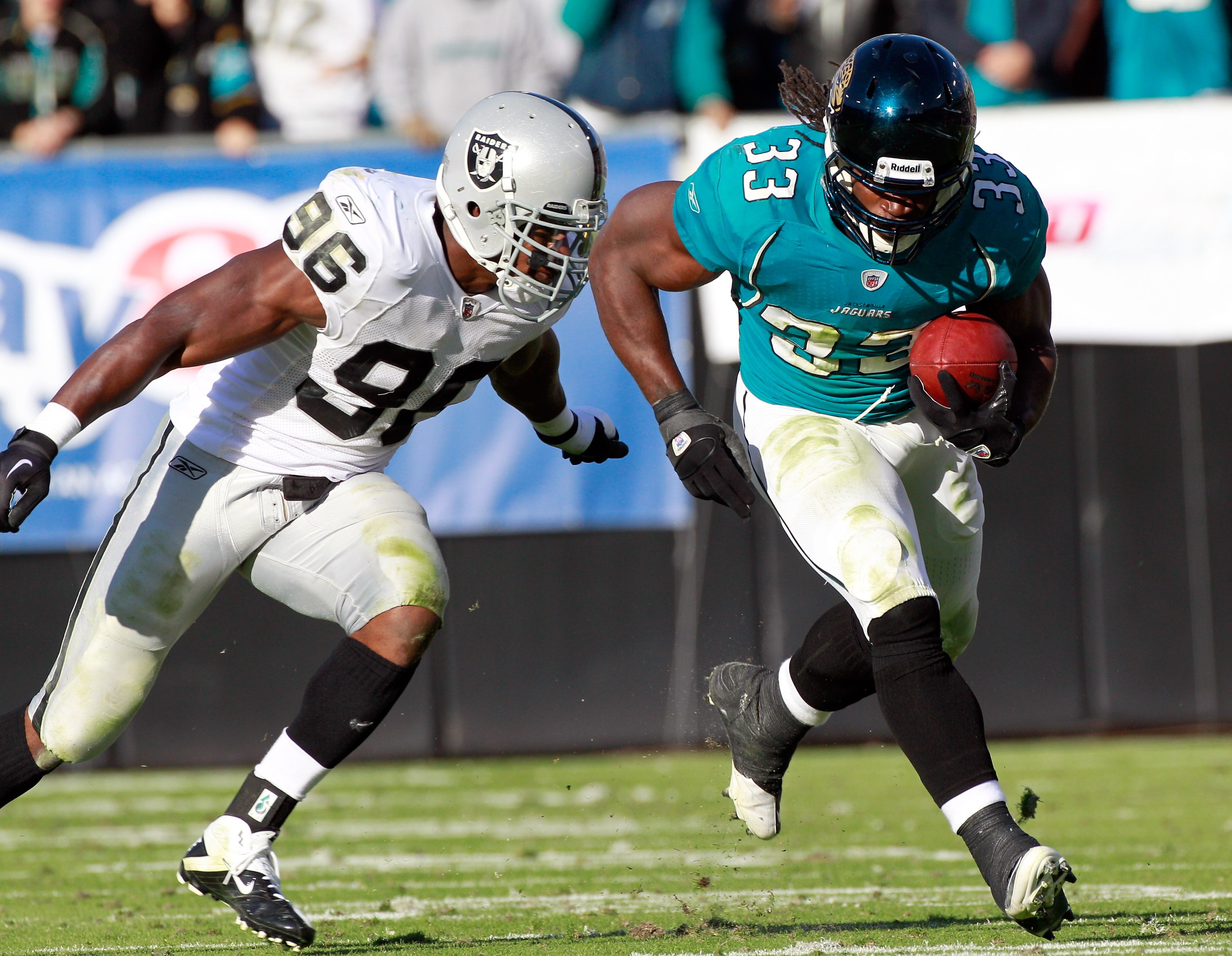 JACKSONVILLE, FL - DECEMBER 12:  Kamerion Wimbley #96 of the Oakland Raiders attempts to tackle Greg Jones #33 of the Jacksonville Jaguars runs during the game at EverBank Field on December 12, 2010 in Jacksonville, Florida.  (Photo by Sam Greenwood/Getty