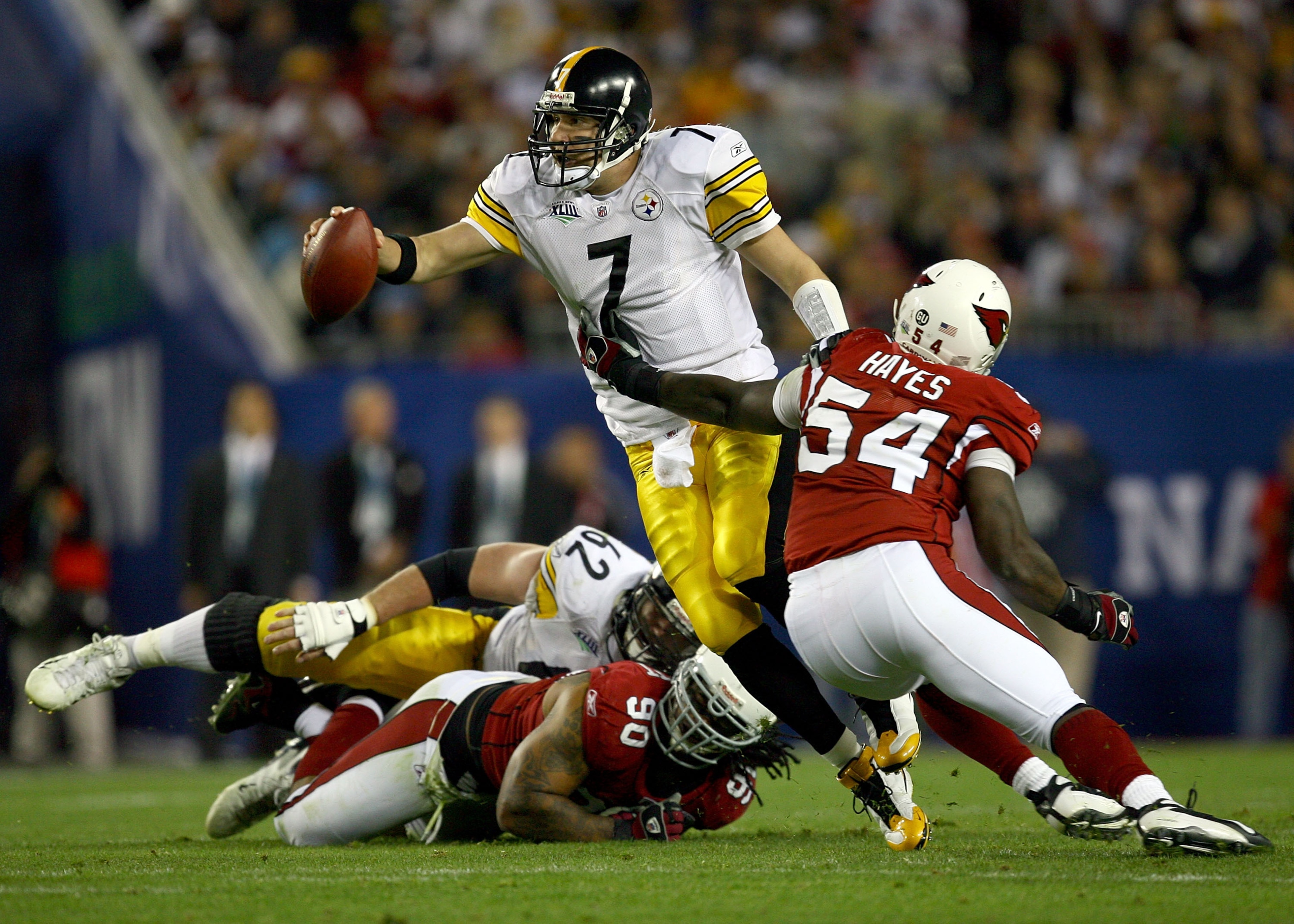 TAMPA, FL - FEBRUARY 01:  Quarterback Ben Roethlisberger #7 of the Pittsburgh Steelers attempts to escape the grasp of Gerald Hayes #54 of the Arizona Cardinals during Super Bowl XLIII on February 1, 2009 at Raymond James Stadium in Tampa, Florida.  (Phot