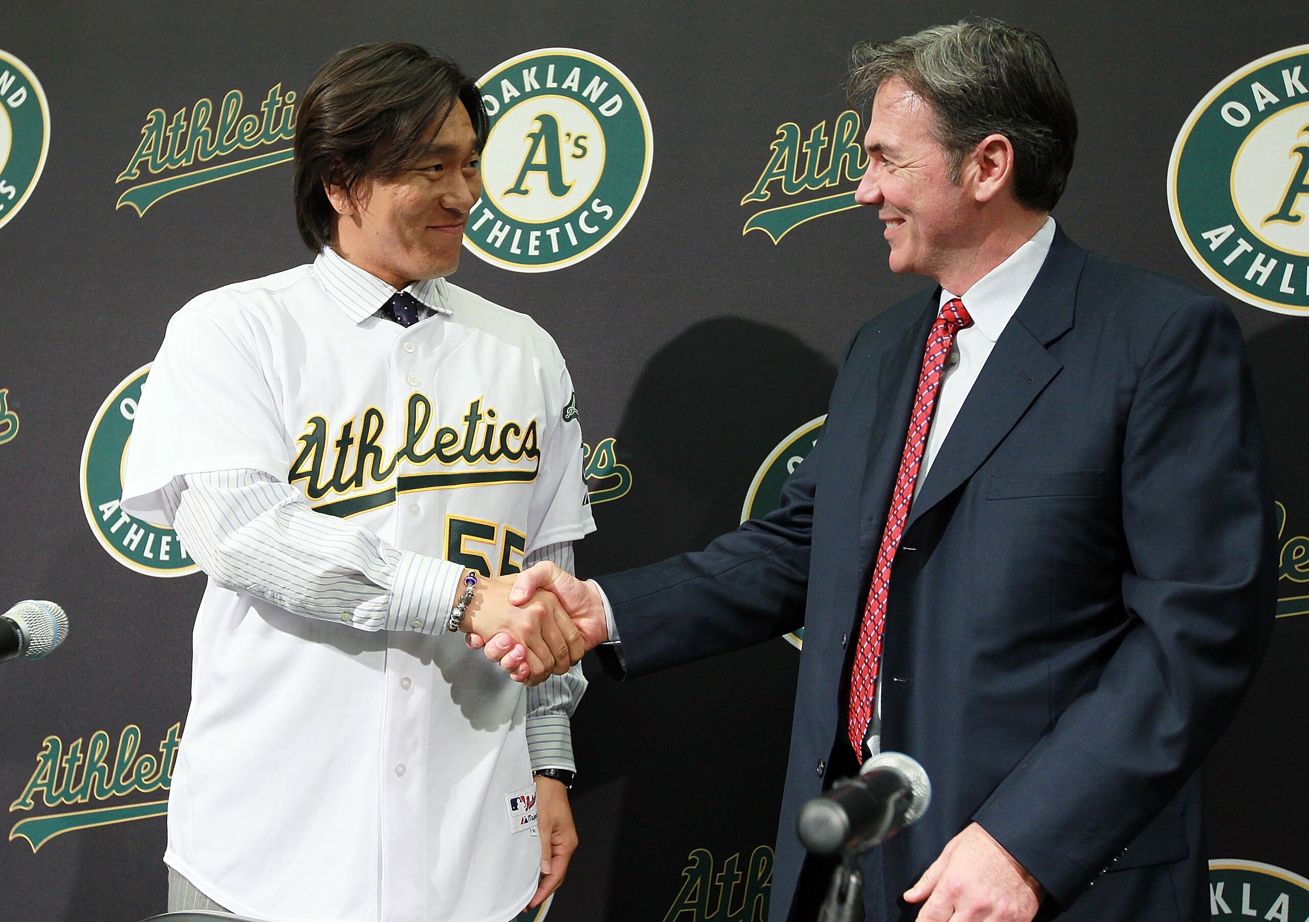 OAKLAND, CA - DECEMBER 14: Hideki Matsui (L) shakes hands with Oakland Athletics general manager Billy Beane (R) after trying on his new jersey during a press conference where he was introduced as the newest member of the Oakland Athletics at Oakland-Ala OAKLAND, CA - DECEMBER 14: Hideki Matsui (L) shakes hands with Oakland Athletics general manager Billy Beane (R) after trying on his new jersey during a press conference where he was introduced as the newest member of the Oakland Athletics at Oakland-Ala