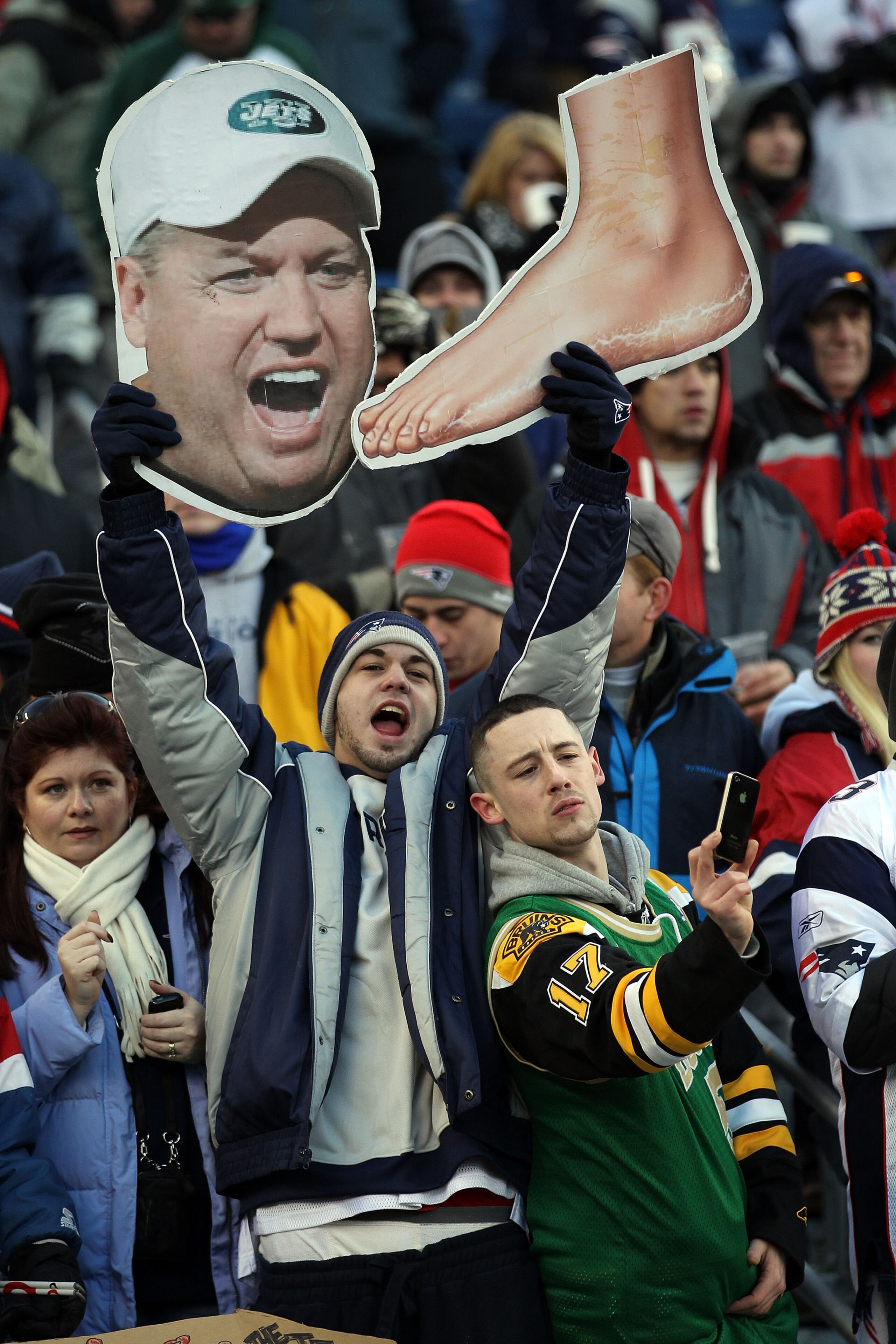 FOXBORO, MA - JANUARY 16:  New England Patriots fans hold up signs picturing head coach Rex Ryan of the New York Jets and a foot prior to their 2011 AFC divisional playoff game at Gillette Stadium on January 16, 2011 in Foxboro, Massachusetts.  (Photo by
