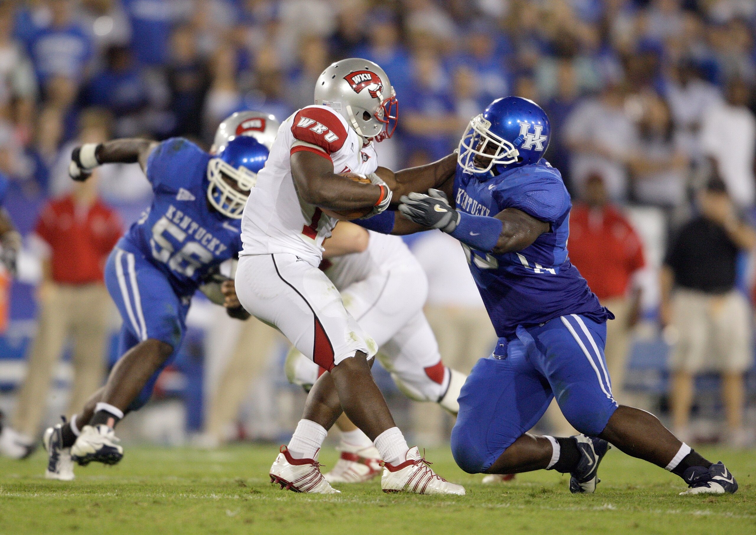 LEXINGTON, KY - SEPTEMBER 27: Ventrell Jenkins #95 of the Kentucky Wildcats tackles Bobby Rainey #17 of the Western Kentucky Hilltoppers during the game at Commonwealth Stadium on September 27, 2008 in Lexington, Kentucky. The Wildcats defeated the Hillt LEXINGTON, KY - SEPTEMBER 27: Ventrell Jenkins #95 of the Kentucky Wildcats tackles Bobby Rainey #17 of the Western Kentucky Hilltoppers during the game at Commonwealth Stadium on September 27, 2008 in Lexington, Kentucky. The Wildcats defeated the Hillt