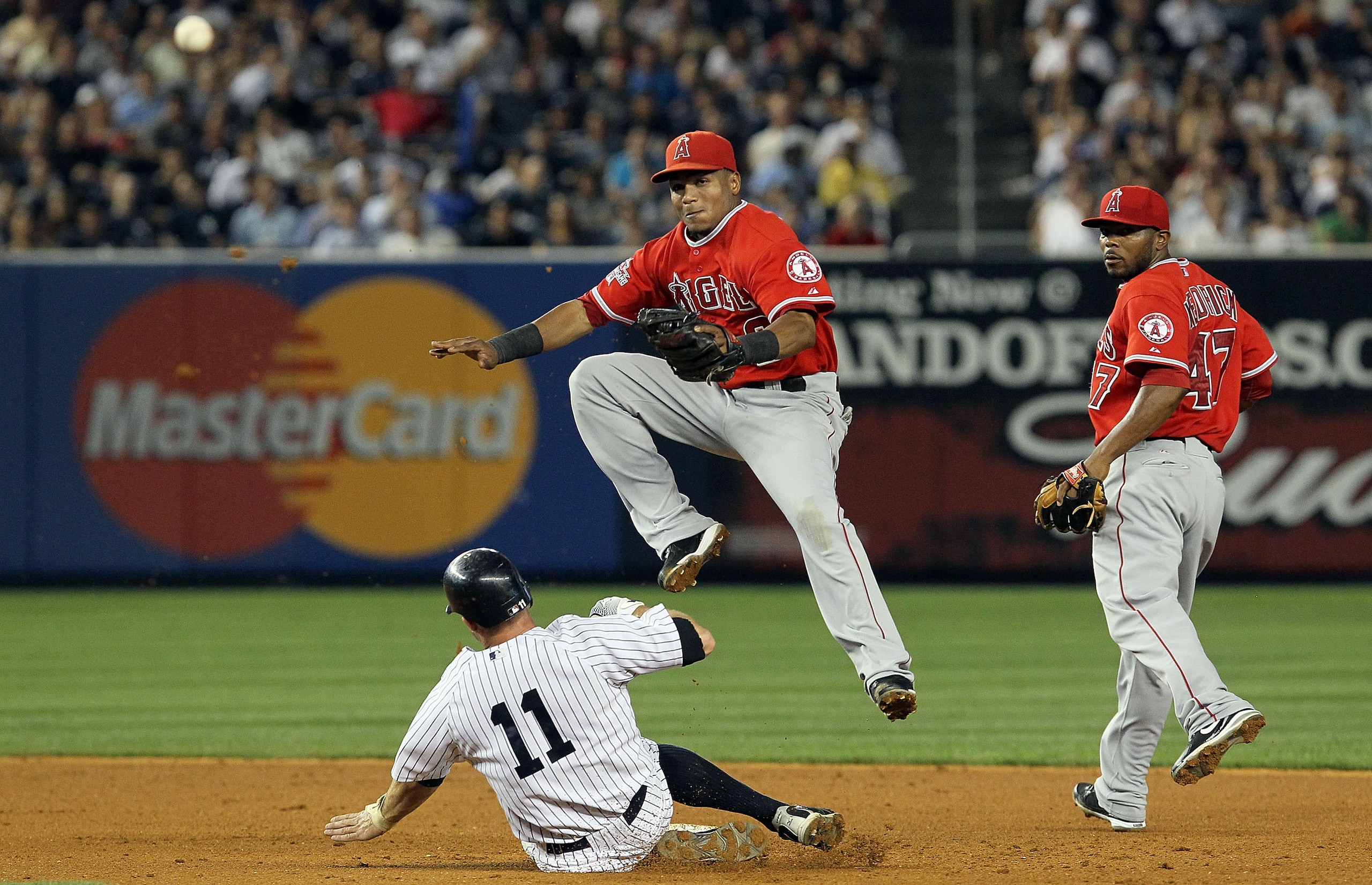 NEW YORK - JULY 20:  Brett Gardner #11 of the New York Yankees is forced out at second base as Erick Aybar #2 of the Los Angeles Angels of Anaheim completes a fifth inning ending double play on July 20, 2010 at Yankee Stadium in the Bronx borough of New Y