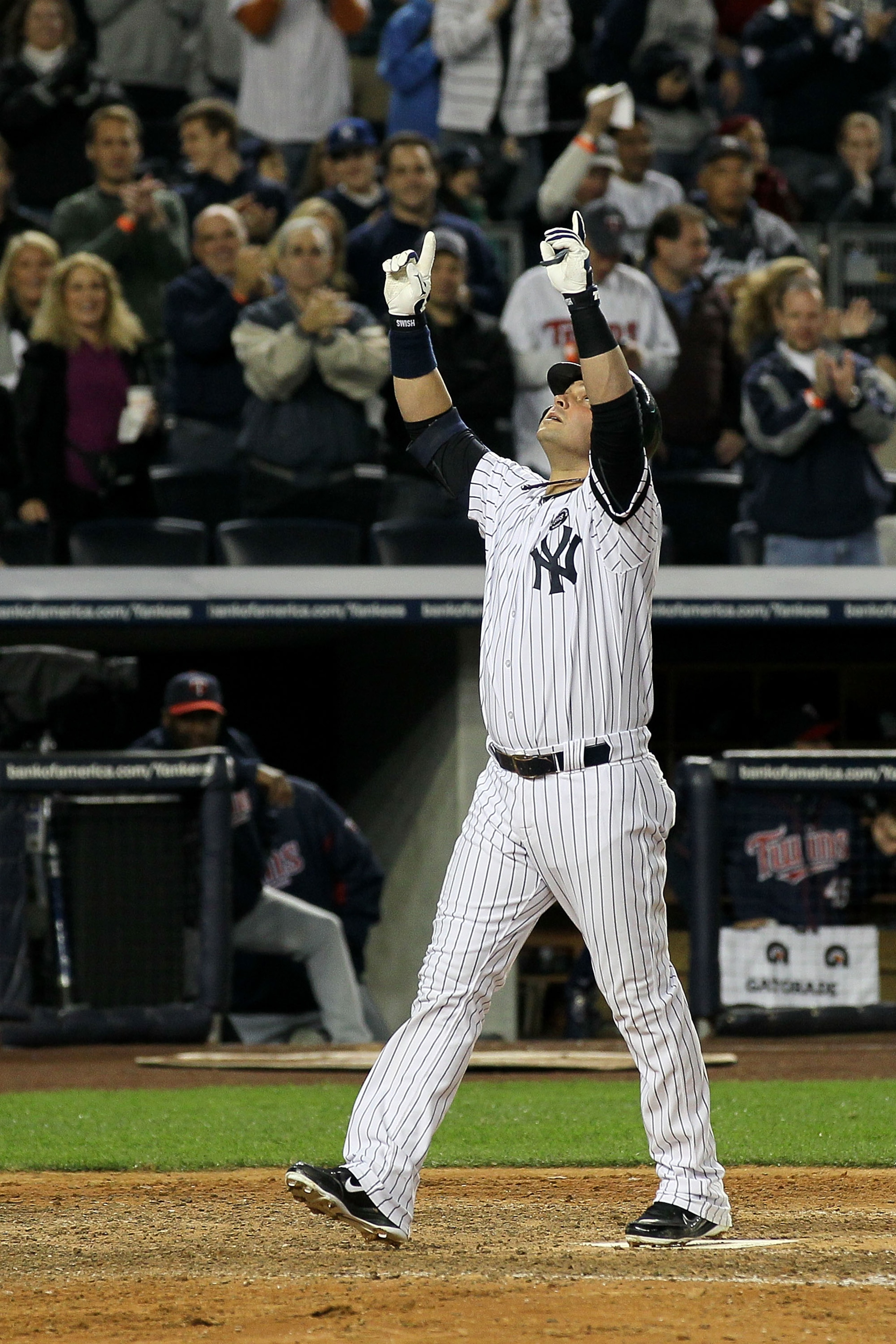 NEW YORK - OCTOBER 09:  Nick Swisher #33 of the New York Yankees celebrates as he crosses home plate after he hit a solo home run in the bottom of the seventh inning against the Minnesota Twins during Game Three of the ALDS part of the 2010 MLB Playoffs a