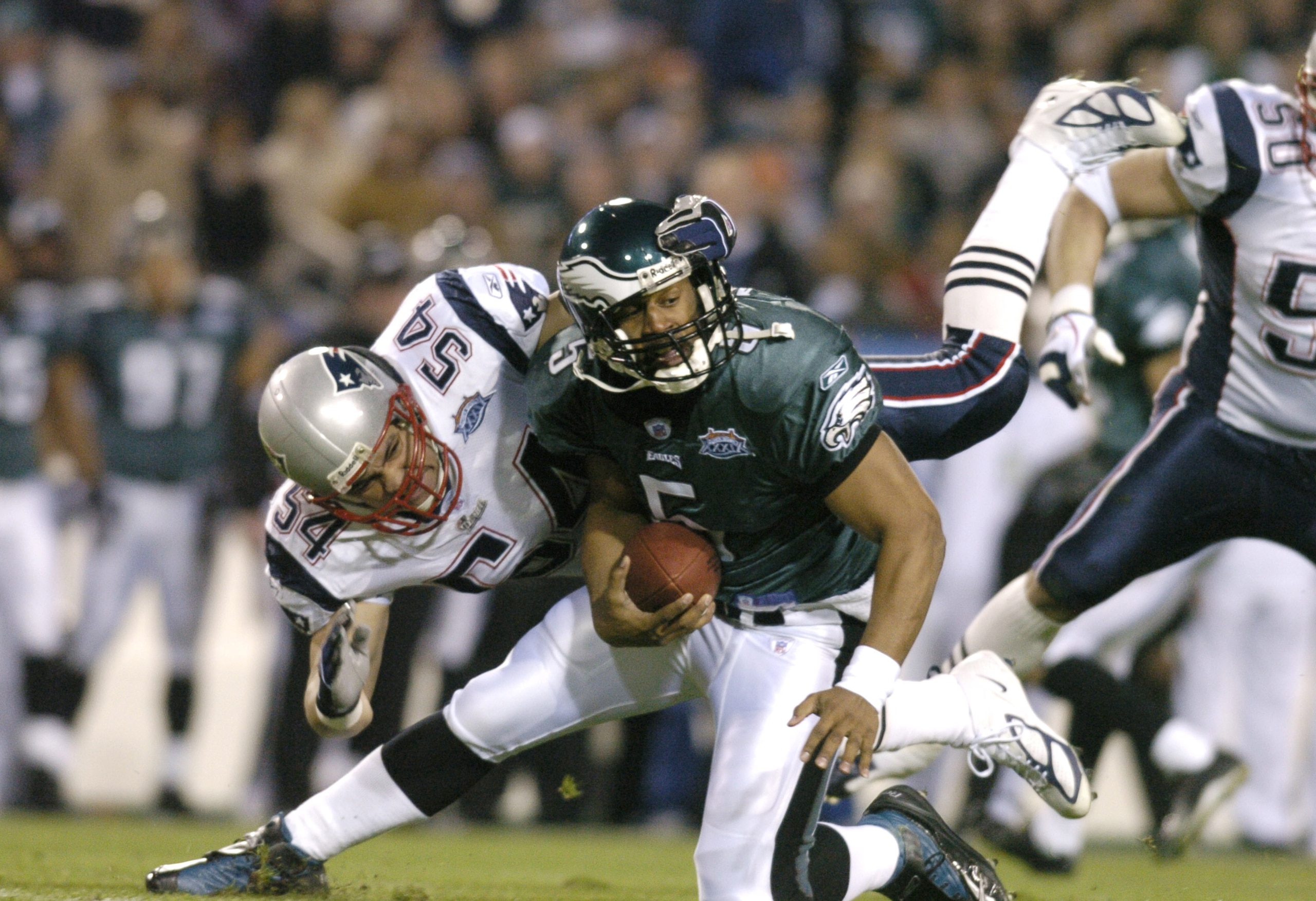 Philadelphia Eagle's QB Donovan McNabb almost gets sacked by New England Patriot Tedy Bruschi during the first quarter of Super Bowl XXXIX between the Philadelphia Eagles and the New England Patriots at Alltel Stadium in Jacksonville, Florida on February Philadelphia Eagle's QB Donovan McNabb almost gets sacked by New England Patriot Tedy Bruschi during the first quarter of Super Bowl XXXIX between the Philadelphia Eagles and the New England Patriots at Alltel Stadium in Jacksonville, Florida on February