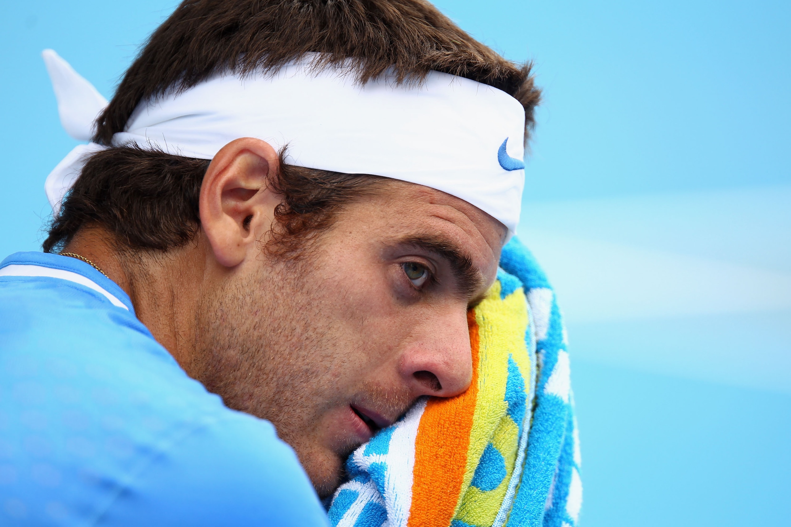 MELBOURNE, AUSTRALIA - JANUARY 18:  Juan Martin Del Potro of Argentina towels down during his first round match against Dudi Sela of Israel during day two of the 2011 Australian Open at Melbourne Park on January 18, 2011 in Melbourne, Australia.  (Photo b