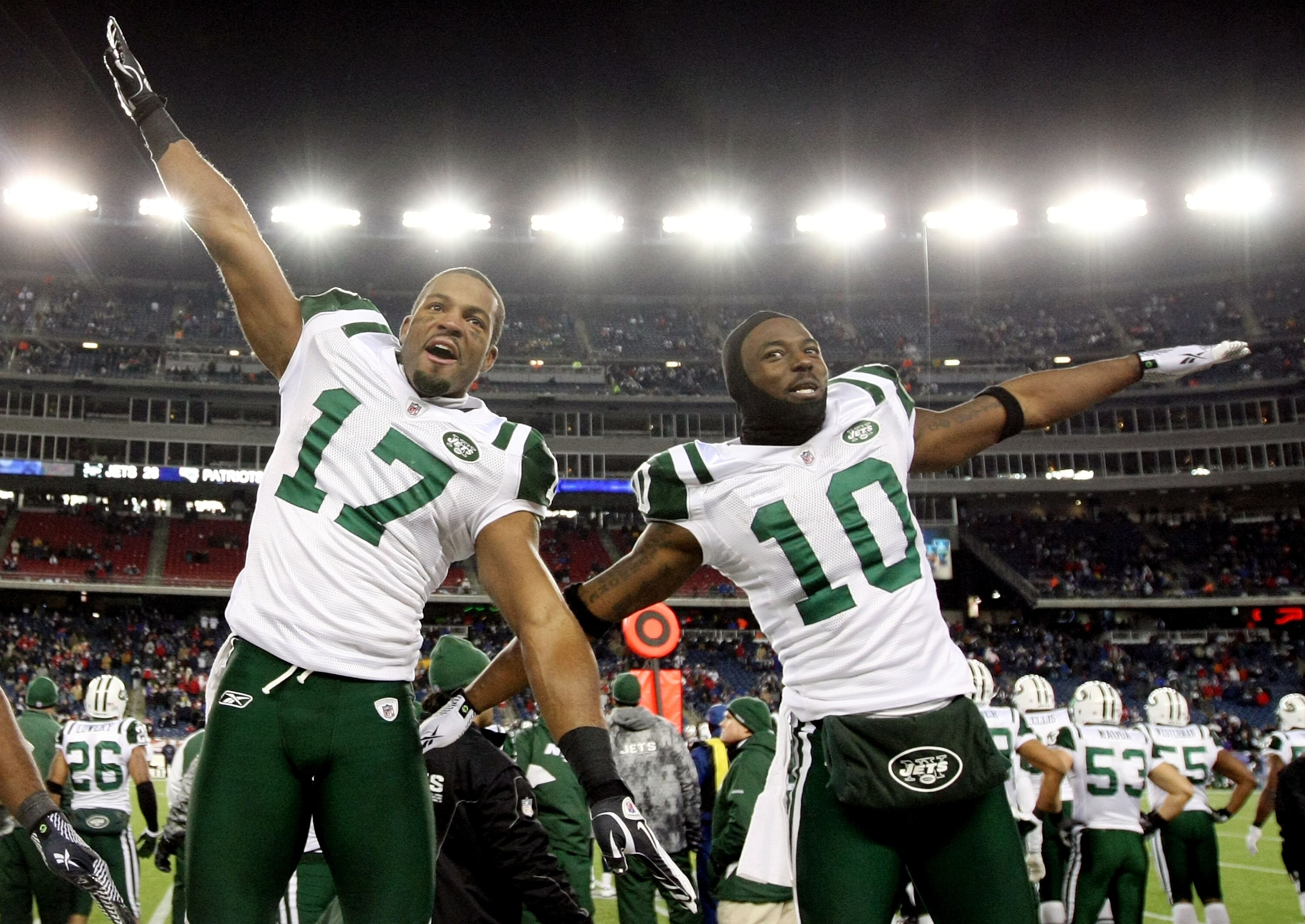 FOXBORO, MA - JANUARY 16:  Braylon Edwards #17 and Santonio Holmes #10 of the New York Jets celebrate on their way to defeating the New England Patriots 28 to 21 victory over the New England Patriots during their 2011 AFC divisional playoff game at Gillet