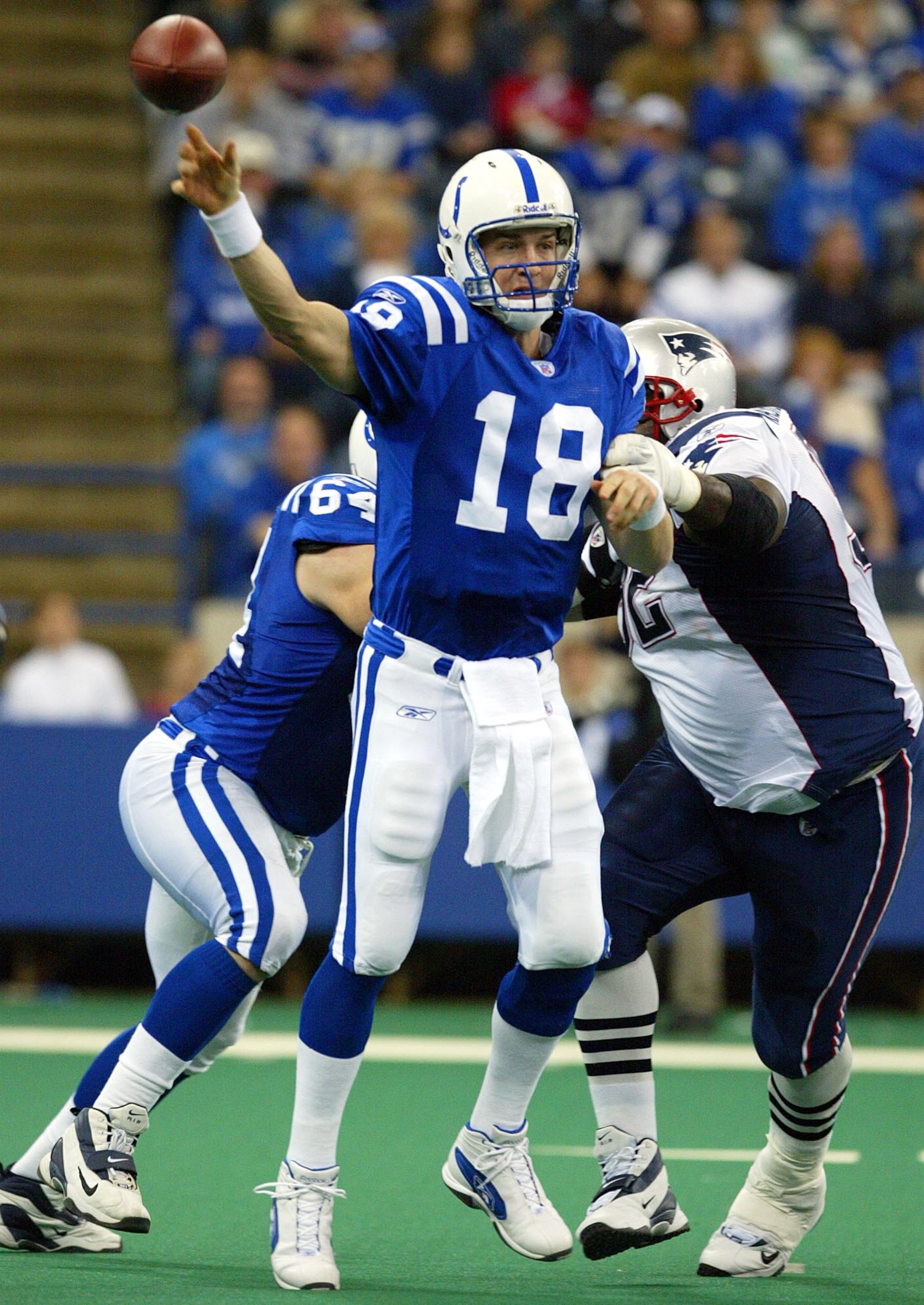 INDIANAPOLIS - NOVEMBER 30:  Peyton Manning #18 of the Indianapolis Colts throws the ball against the New England Patriots on November 30, 2003 at the RCA Dome in Indianapolis, Indiana.  (Photo by Andy Lyons/Getty Images)
