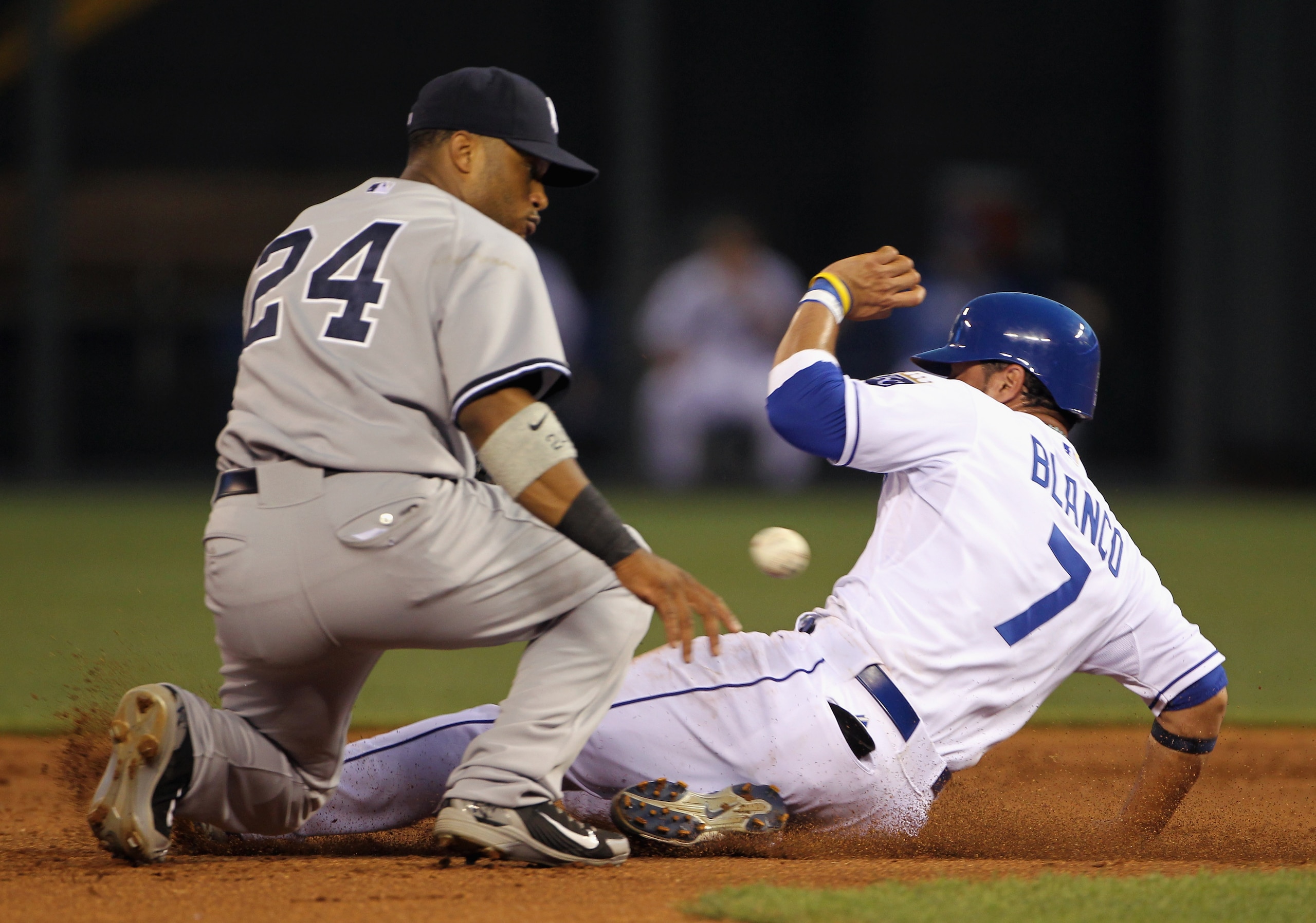 KANSAS CITY, MO - AUGUST 13:  Gregor Blanco #7 of the Kansas City Royals steals 2nd base as Robinson Cano #24 of the New York Yankees waits for the ball during the 1st inning of the game on August 13, 2010 at Kauffman Stadium in Kansas City, Missouri.  (P