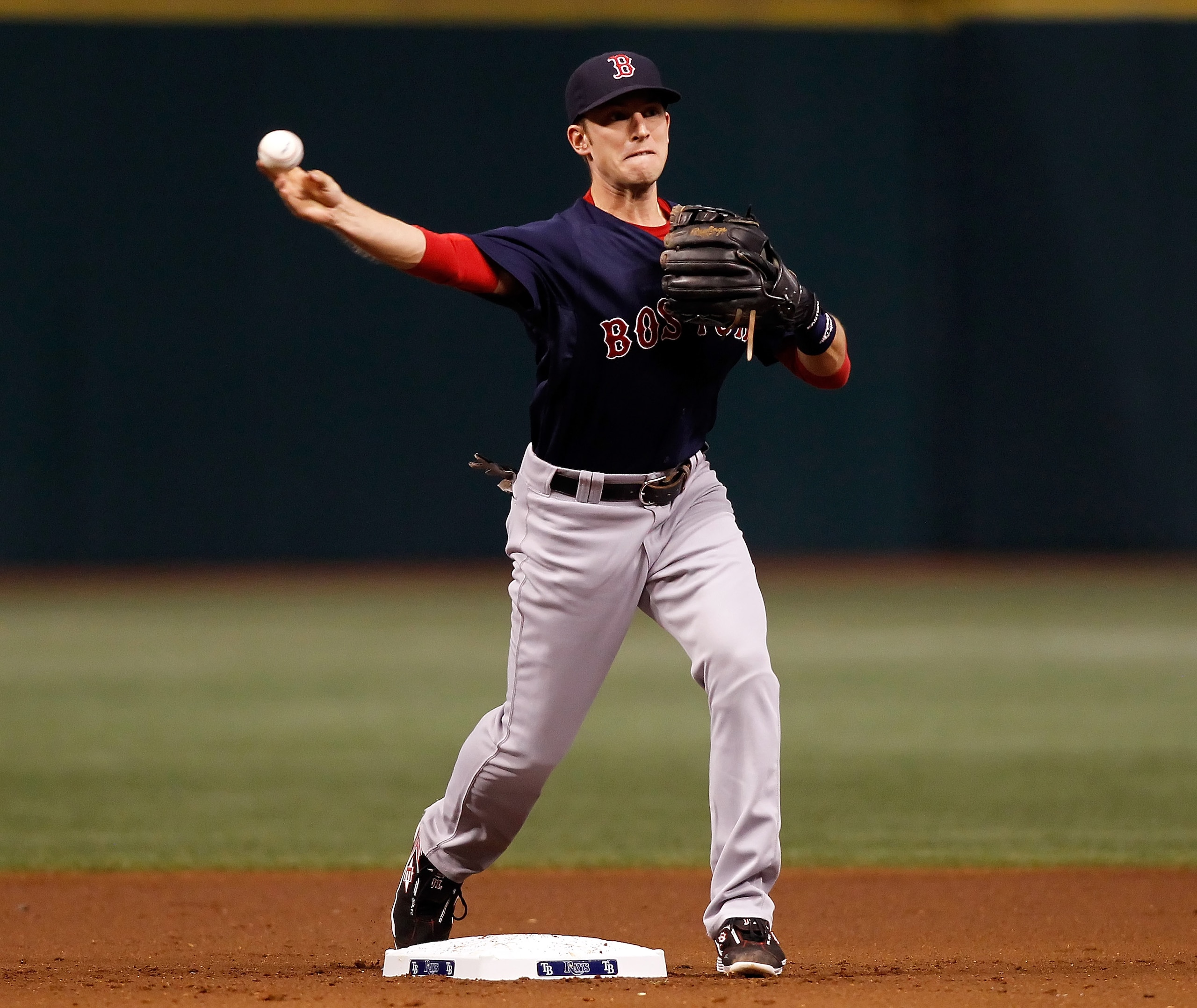 ST. PETERSBURG - AUGUST 27:  Infielder Jed Lowrie #12 of the Boston Red Sox throws over to first for an out against the Tampa Bay Rays during the game at Tropicana Field on August 27, 2010 in St. Petersburg, Florida.  (Photo by J. Meric/Getty Images)