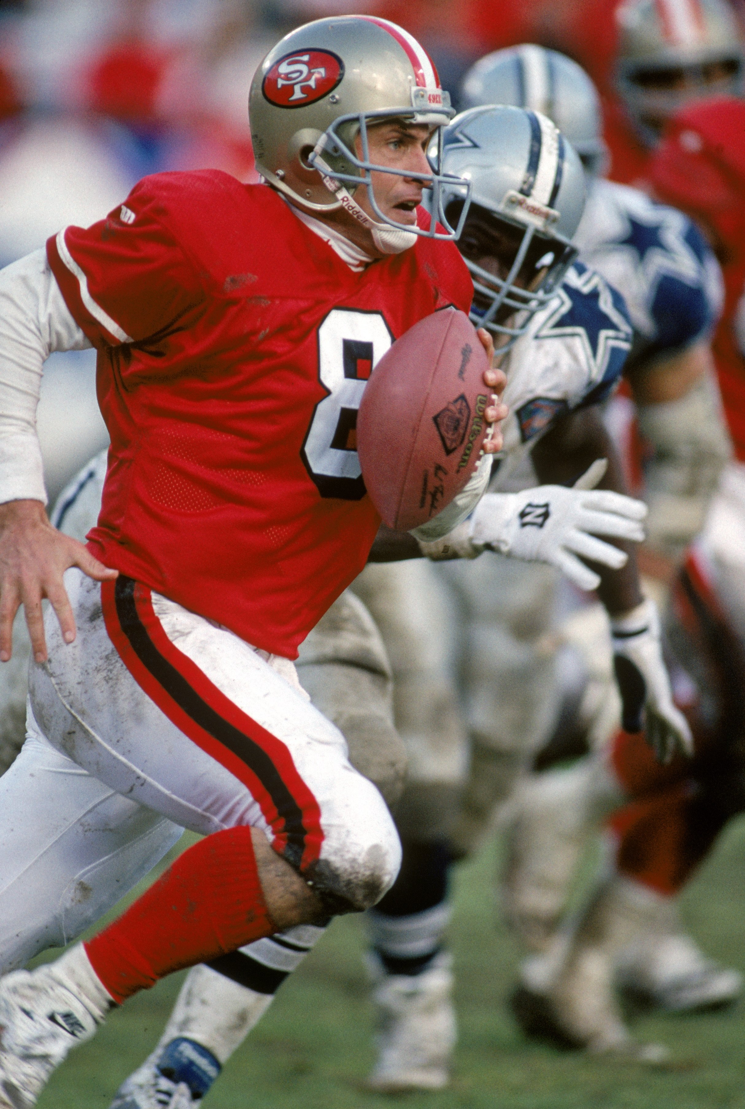 SAN FRANCISCO - JANUARY 15:  Quarterback Steve Young #8 of the San Francisco 49ers finds room to run with the ball against the Dallas Cowboys during the 1994 NFC Championship game at Candlestick Park on January 15, 1995 in San Francisco, California.  The
