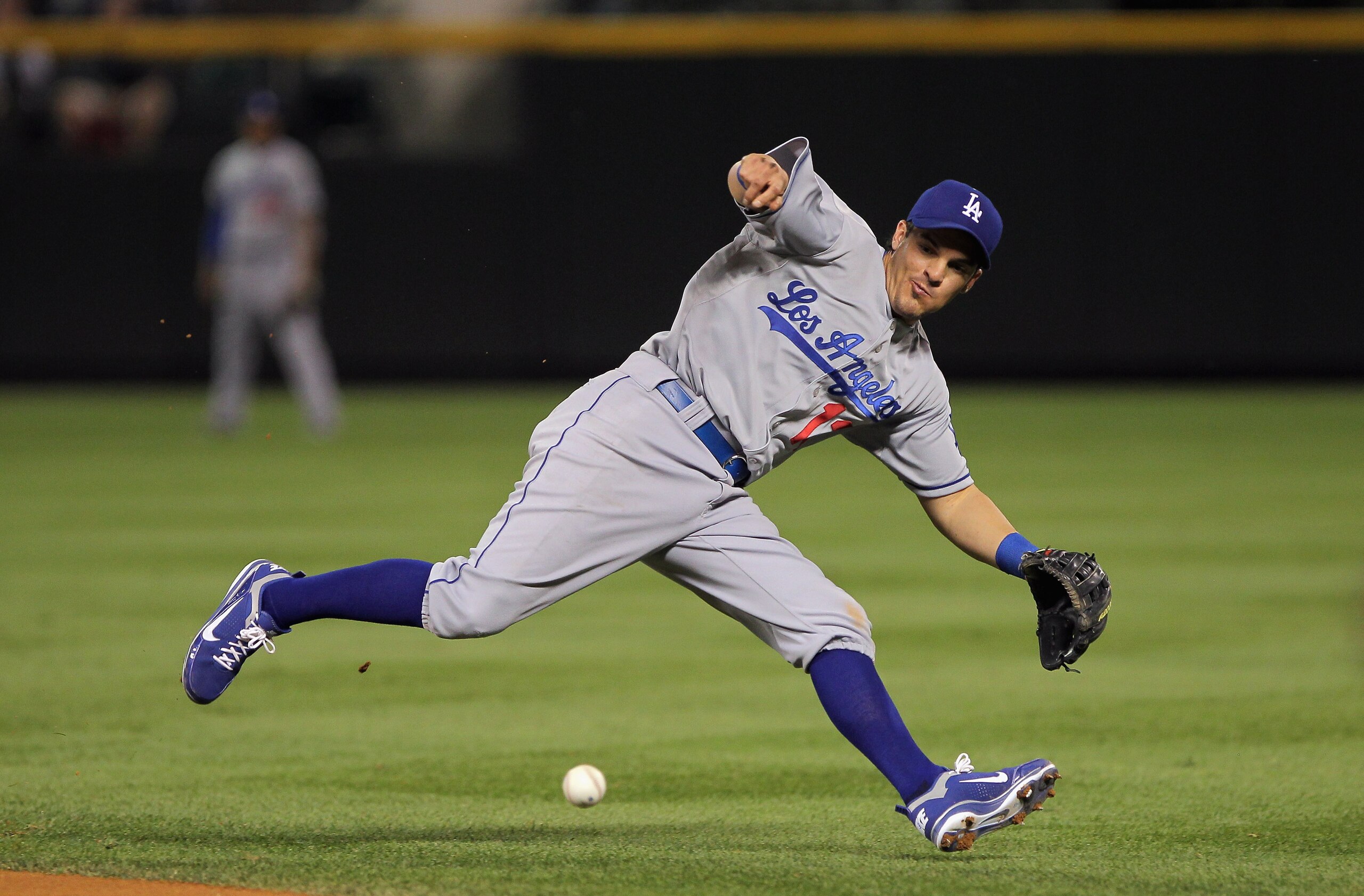 DENVER - SEPTEMBER 27:  Second baseman Ryan Theriot #13 of the Los Angeles Dodgers makes the stop on a ground ball by Todd Helton of the Colorado Rockies but looses the handle on the ball and is unable to throw out Helton at Coors Field on September 25, 2