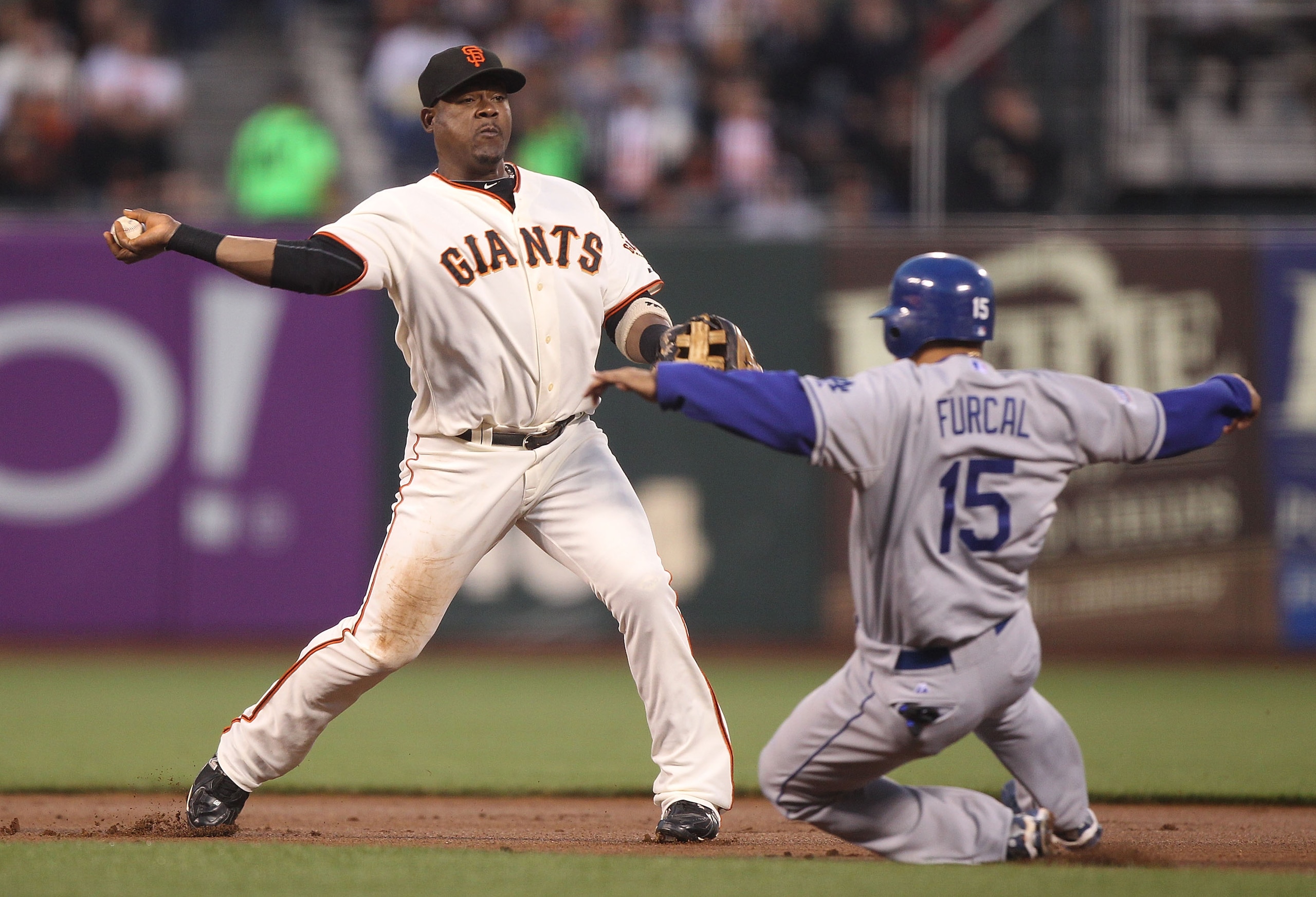 SAN FRANCISCO - SEPTEMBER 14:  Juan Uribe #5 of the San Francisco Giants throws to first as Rafael Furcal #15 of the Los Angeles Dodgers slides into second on a double play ball hit by Andre Ethier in the first inning during a Major League Baseball game a