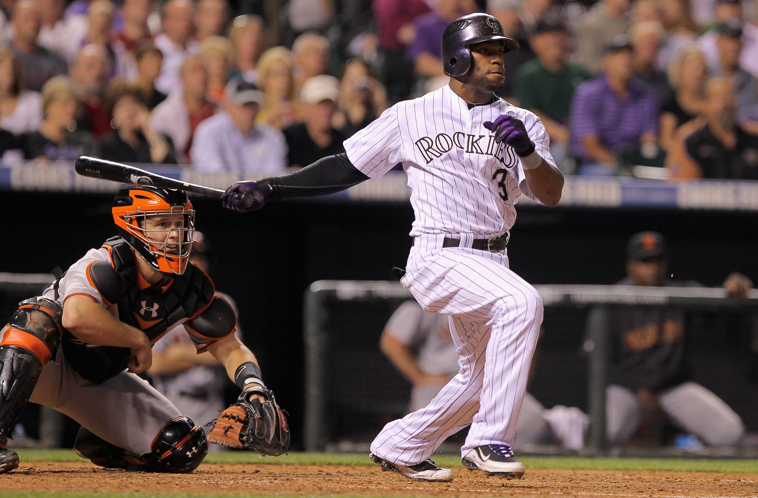 DENVER - SEPTEMBER 24:  Eric Young Jr #3 of the Colorado Rockies follows through on his RBI single to score Seth Smith in the sixth inning against the San Francisco Giants at Coors Field on September 24, 2010 in Denver, Colorado. The Giants defeated the R