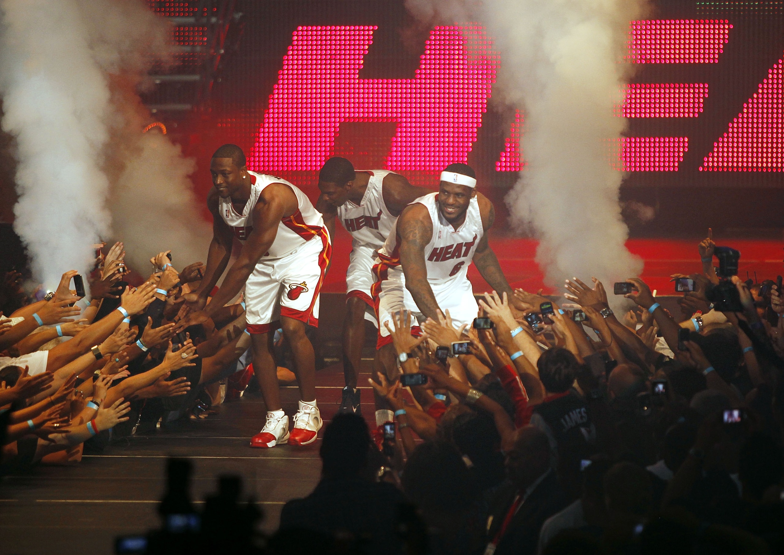 MIAMI - JULY 09:  Fans cheer as (L-R) Dwyane Wade #3, Chris Bosh #1 and LeBron James #6 of the Miami Heat are introduced during a welcome party at American Airlines Arena on July 9, 2010 in Miami, Florida.  (Photo by Marc Serota/Getty Images)