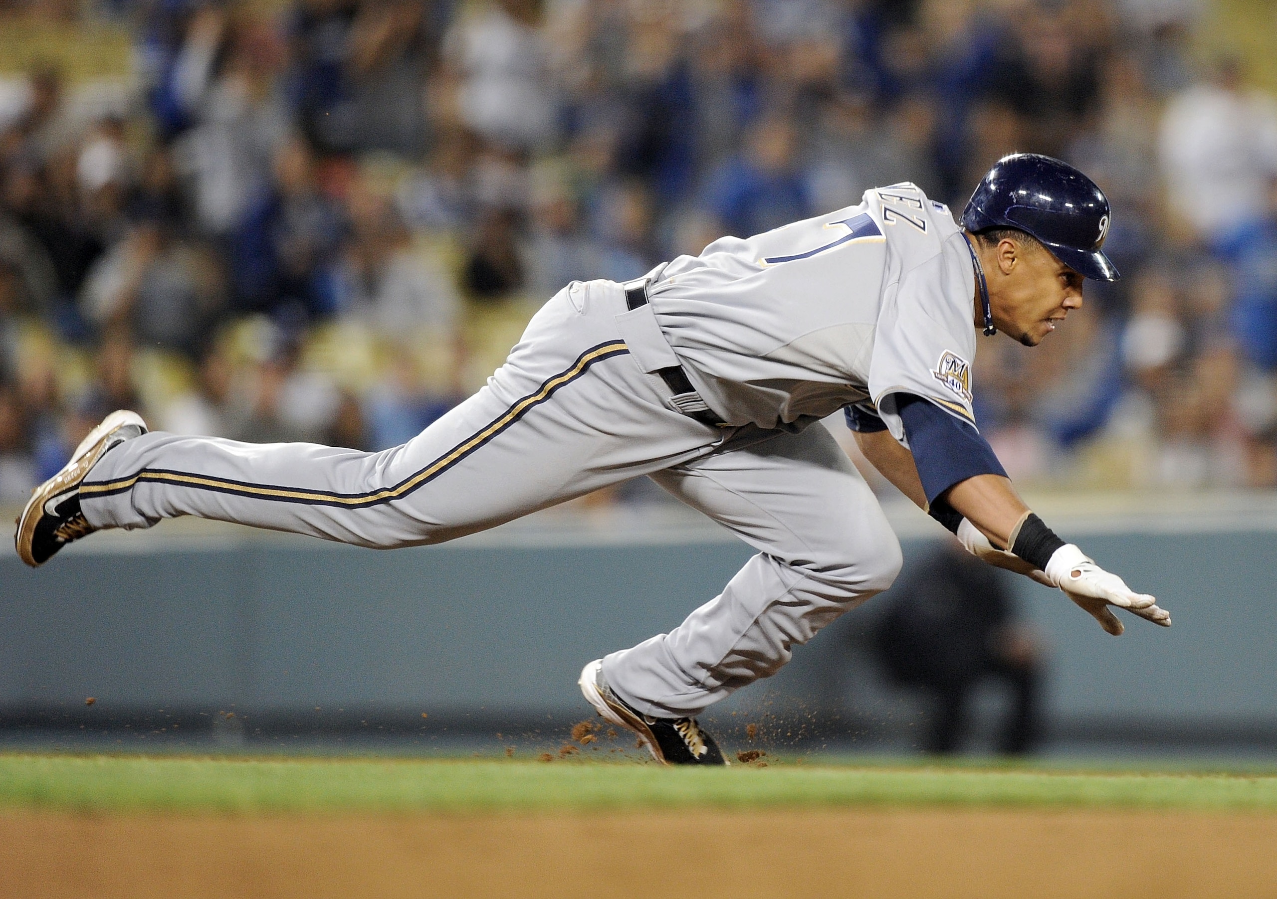 LOS ANGELES, CA - MAY 05:  Carlos Gomez #27 of the Milwaukee Brewers dives back into 2nd base during a run down in the eighth inning against the Los Angeles Dodgers at Dodger Stadium on May 5, 2010 in Los Angeles, California.  (Photo by Harry How/Getty Im