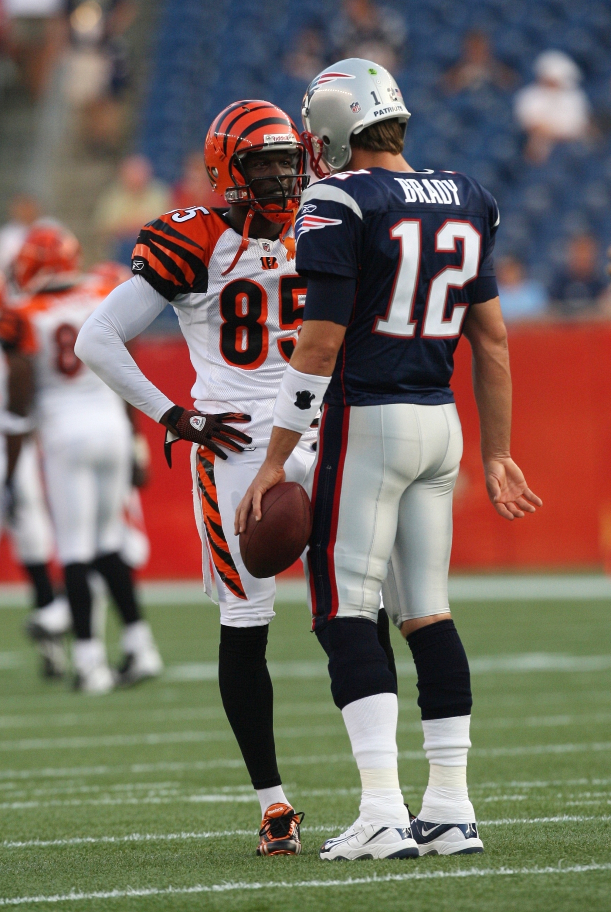 New England Patriots Tom Brady (12) and Chad Ochocinco stand in the huddle  in the second quarter against the New York Jets in week 10 of the NFL  season at MetLife Stadium