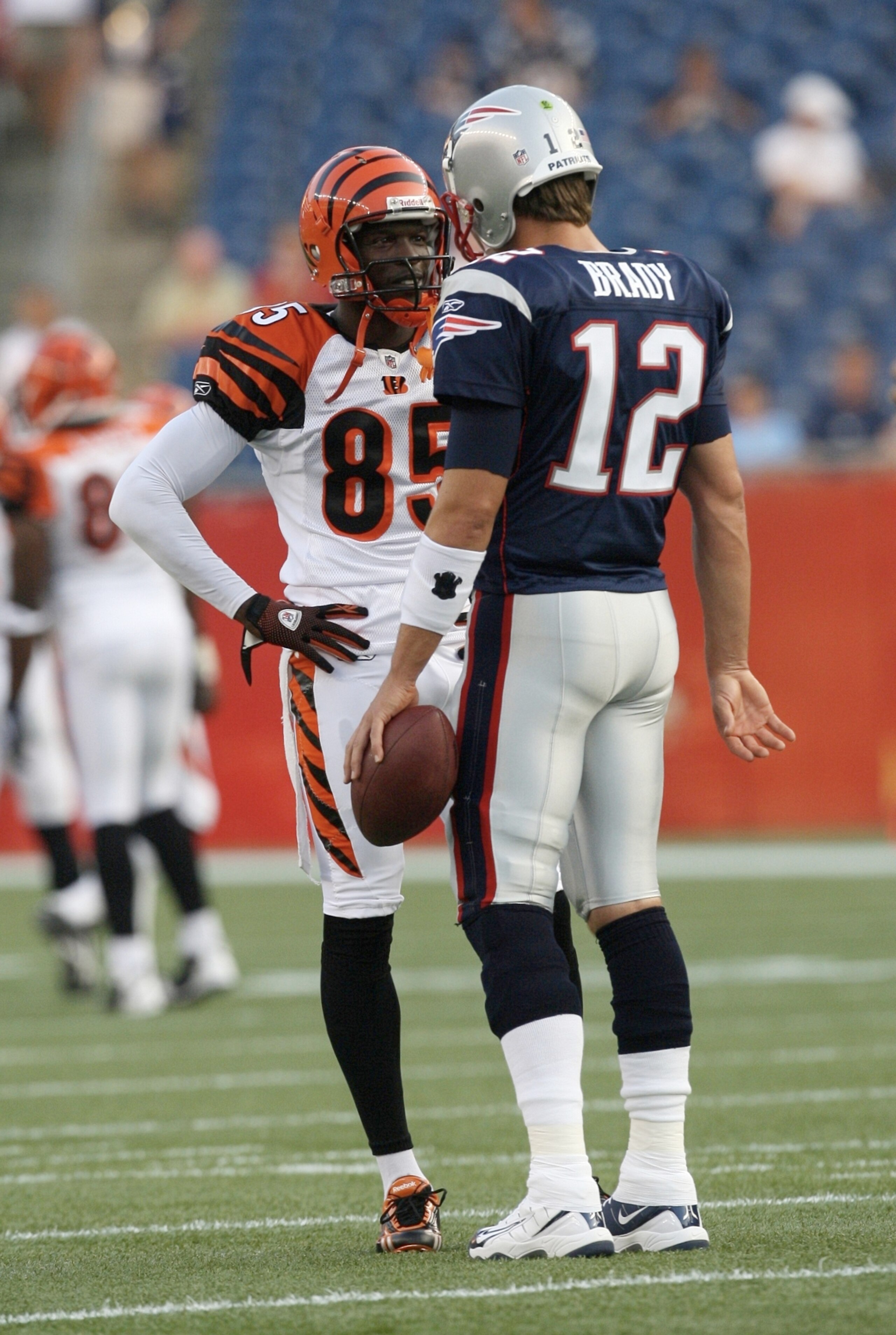 FOXBORO, MA - AUGUST 20:  Chad Ochocinco #85 of the Cincinnati Bengals talks with Tom Brady #12 of the New England Patriots during their preseason game at Gillette Stadium on August 20, 2009 in Foxboro, Massachusetts.  (Photo by Jim Rogash/Getty Images)
